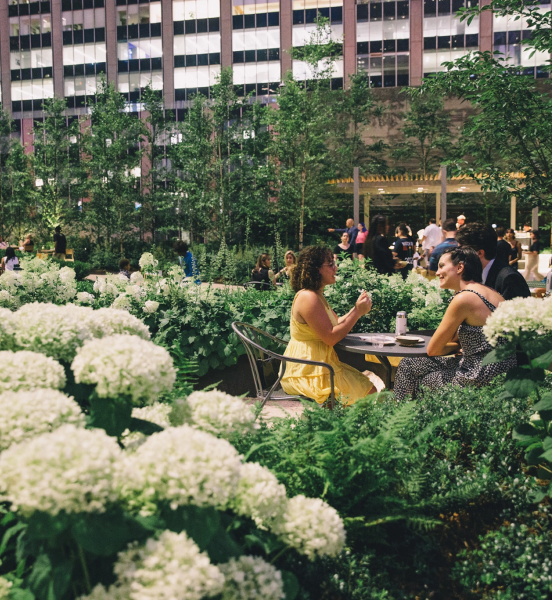 Two people sitting at a table at Radio Park at Rockefeller Center