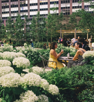 Two people sitting at a table at Radio Park at Rockefeller Center