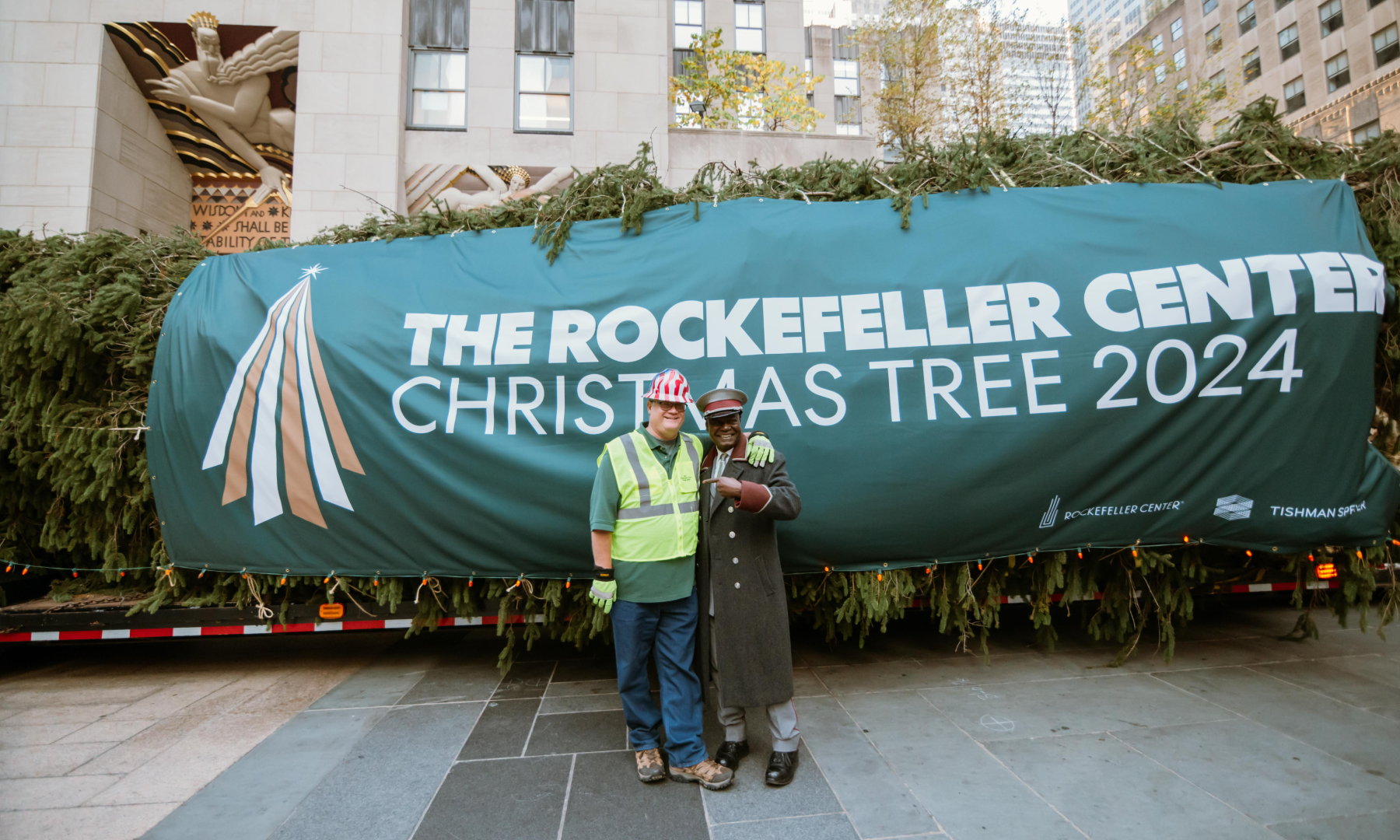 Erik Pauze and Correll Jones stand in front of the 2024 Rockefeller Center Christmas Tree