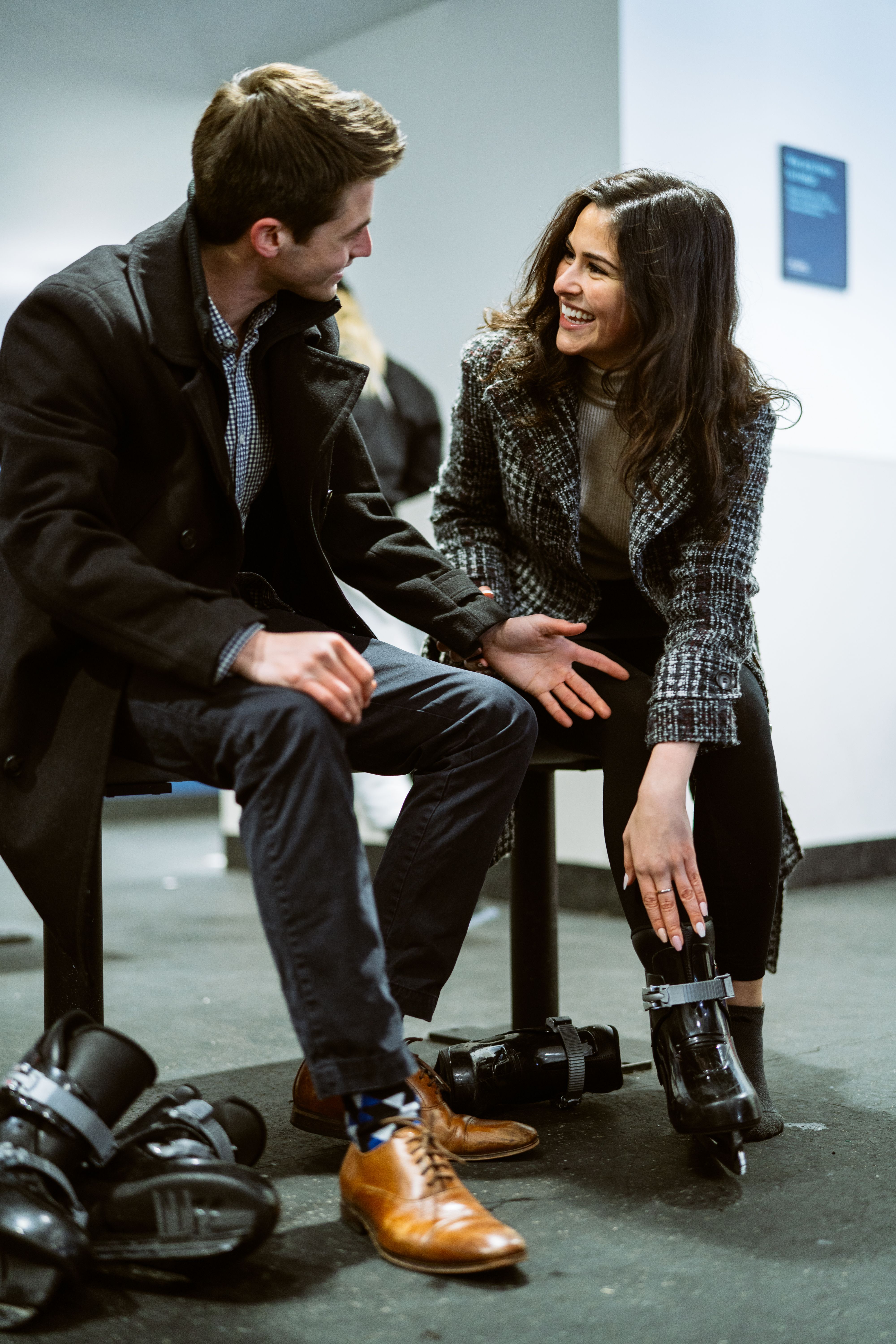 Couple putting skates on at The Rink at Rockefeller Center