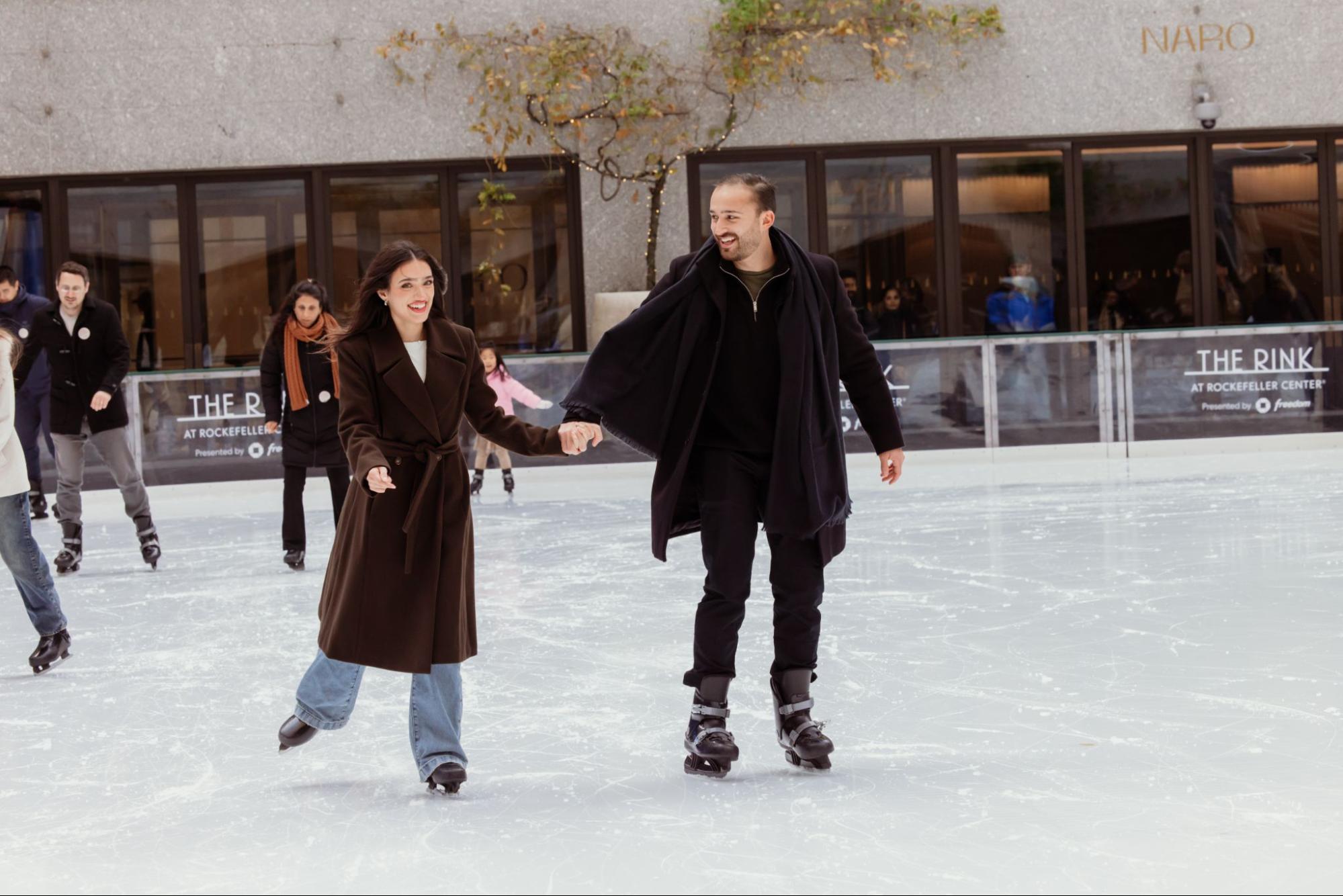 two skaters on the rink at rockefeller center