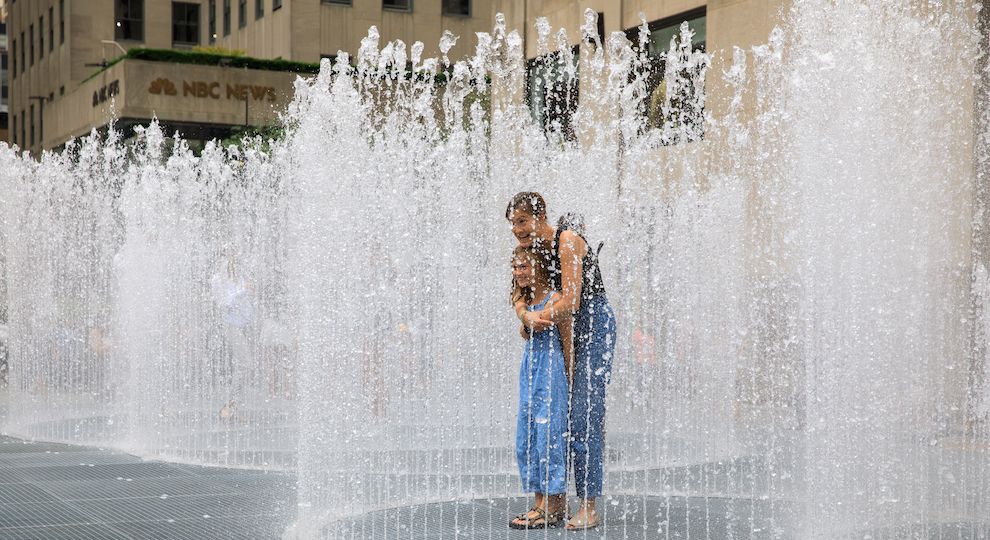 Mother and daughter standing in the middle of artist Jeppe Hein's interactive installation "Changing Spaces" at Rockefeller Center