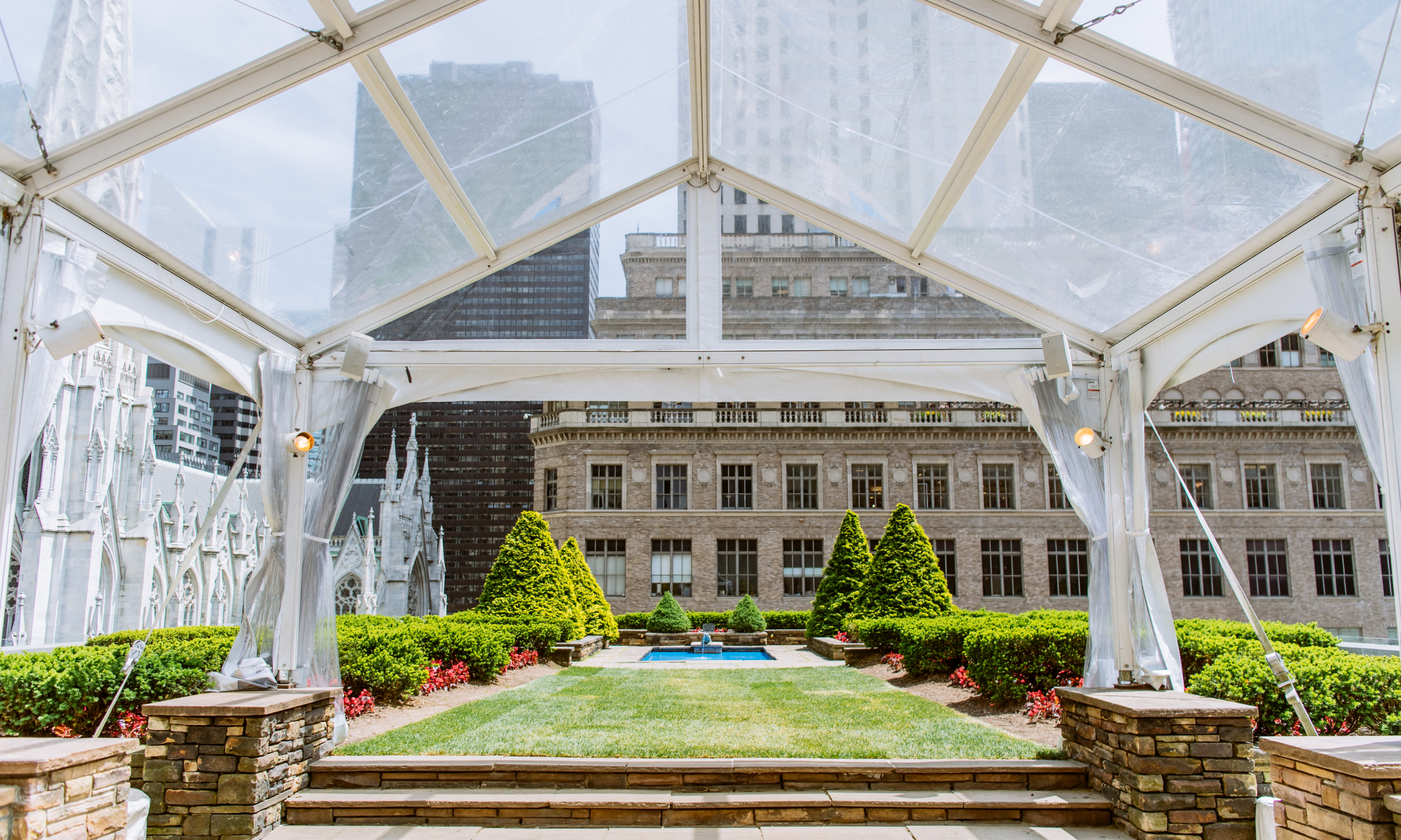 View of the lawn at 610 and 620 Loft & Garden from underneath a clear tent