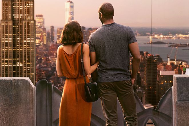 A couple embraces each other while watching a romantic sunset from Top of the Rock.