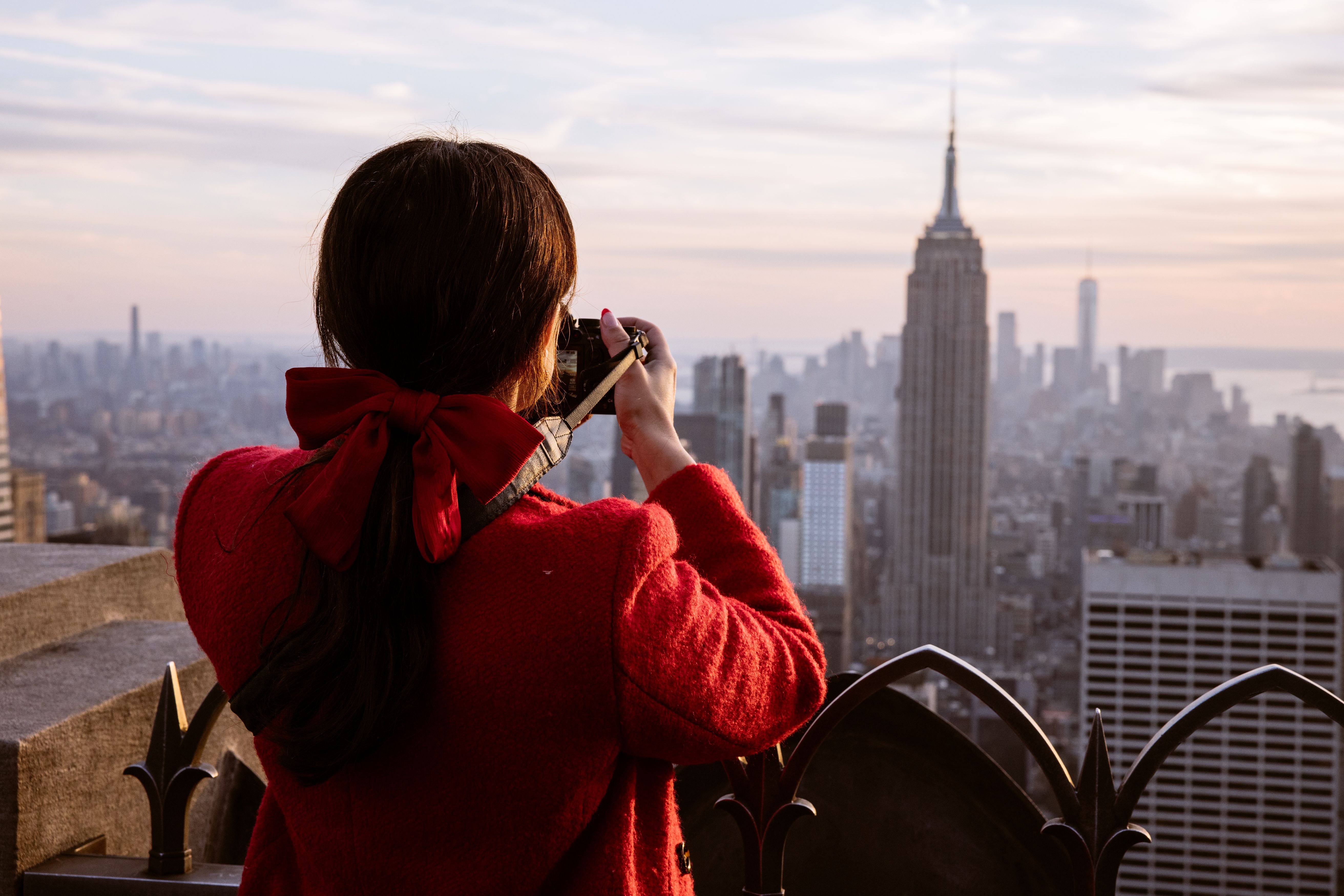 woman taking a photo at top of the rock