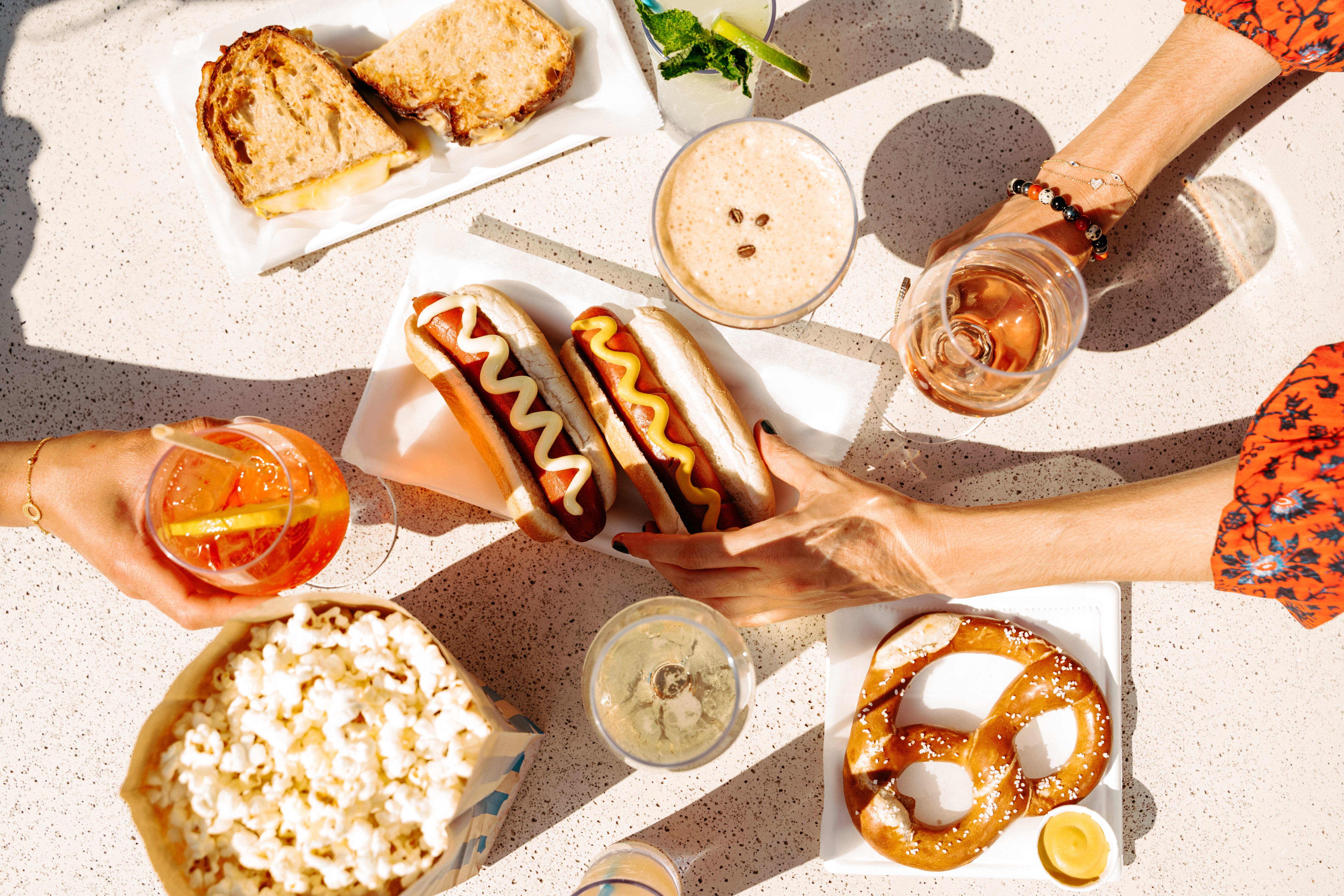 hot dogs, popcorn, cocktails, pretzels and snacks