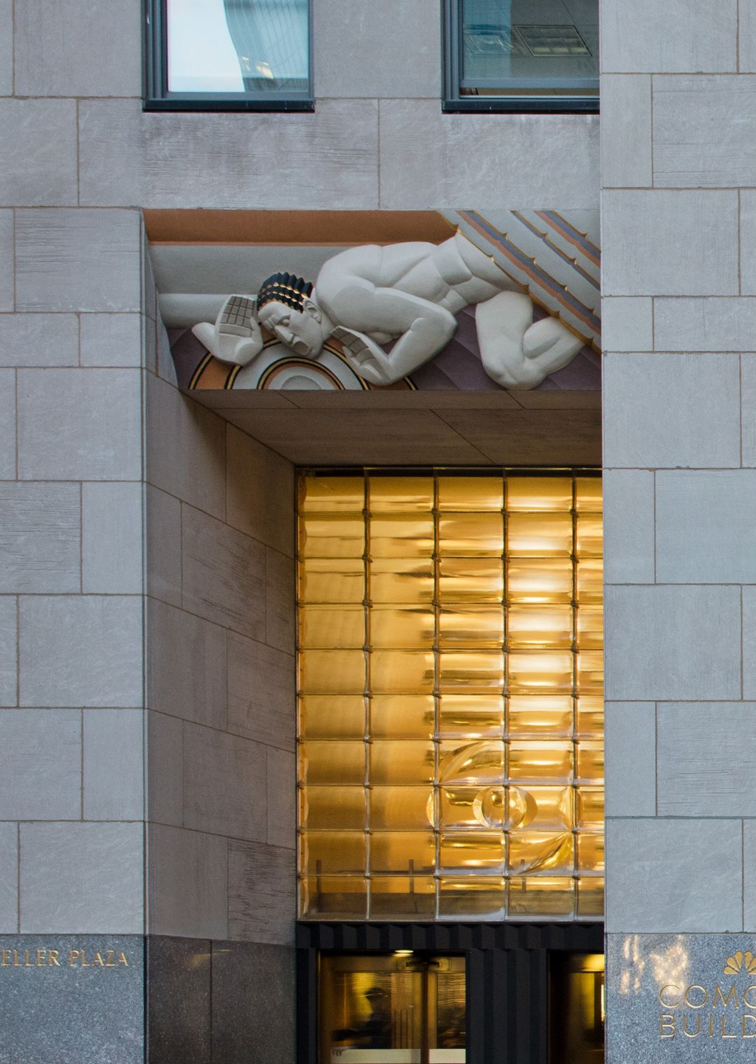 Sound and Light sculptures by Lee Lawrie, above main entrance of 30 Rockefeller Plaza.