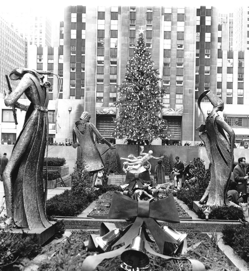 Construction workers line up for pay beside the first Rockefeller Center Christmas tree in New York in 1931.