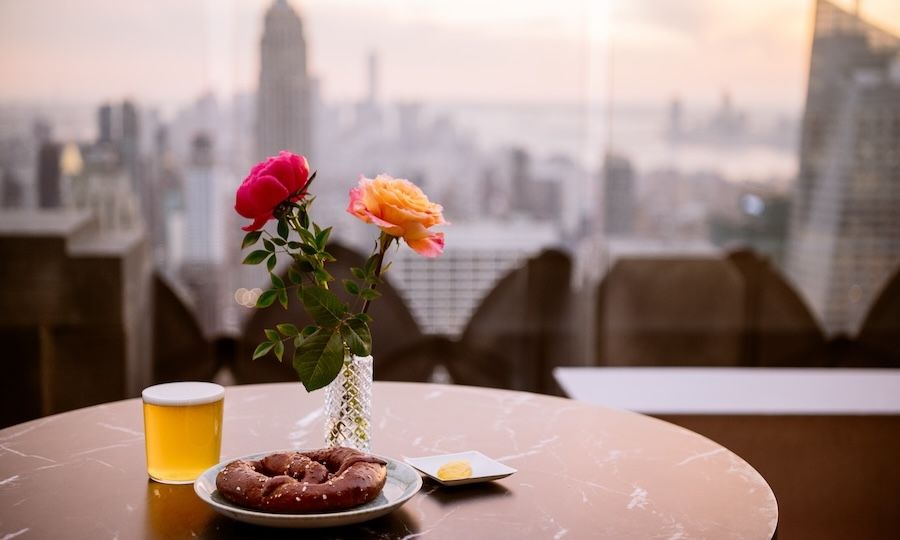 Vase of flowers, pretzel, and a drink at The Weather Room at Top of the Rock