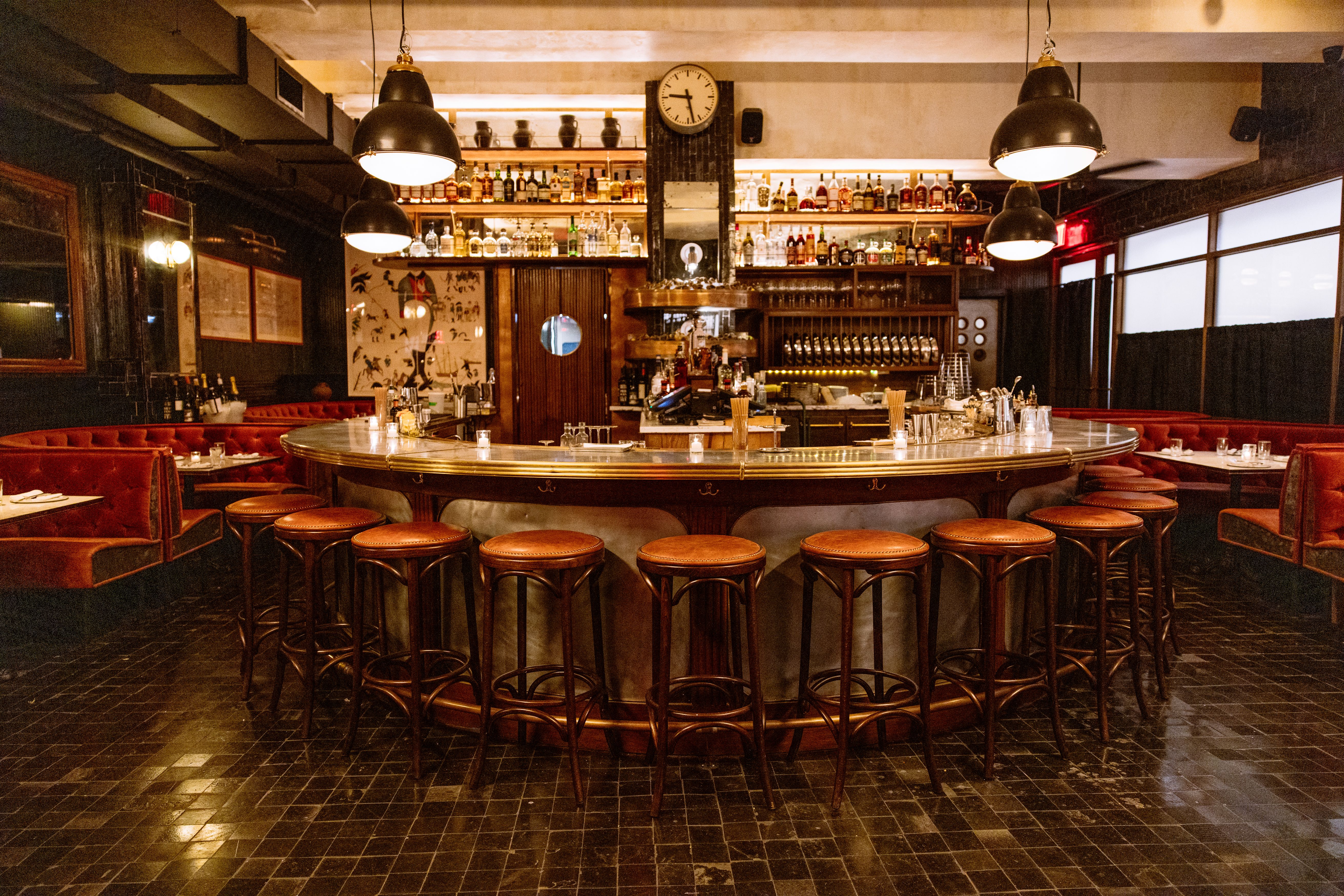 Curved bar with red barstools around it