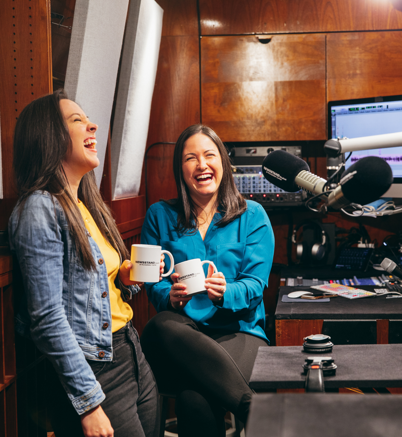 Pamela Riley and Sarah Armstrong-Brown laughing while recording a podcast