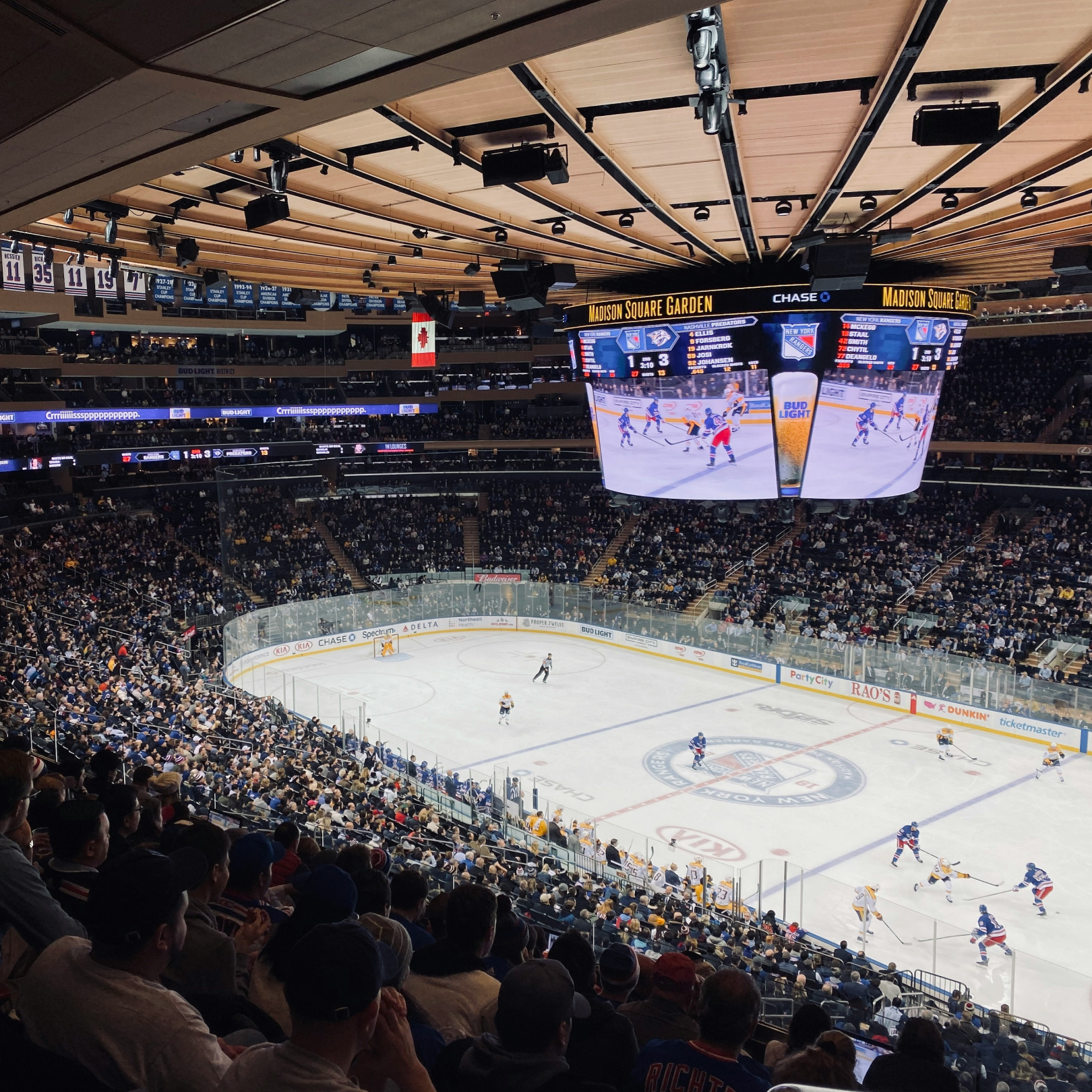 A crowd of people watching a New York Rangers game at Madison Square Garden