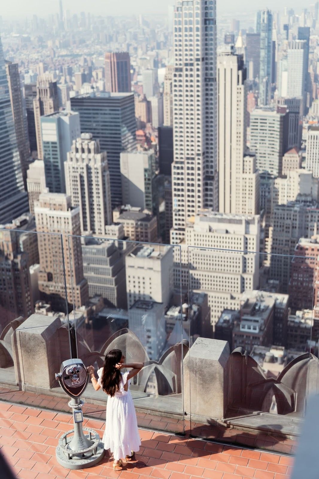 woman standing at Top of the Rock overlooking the city
