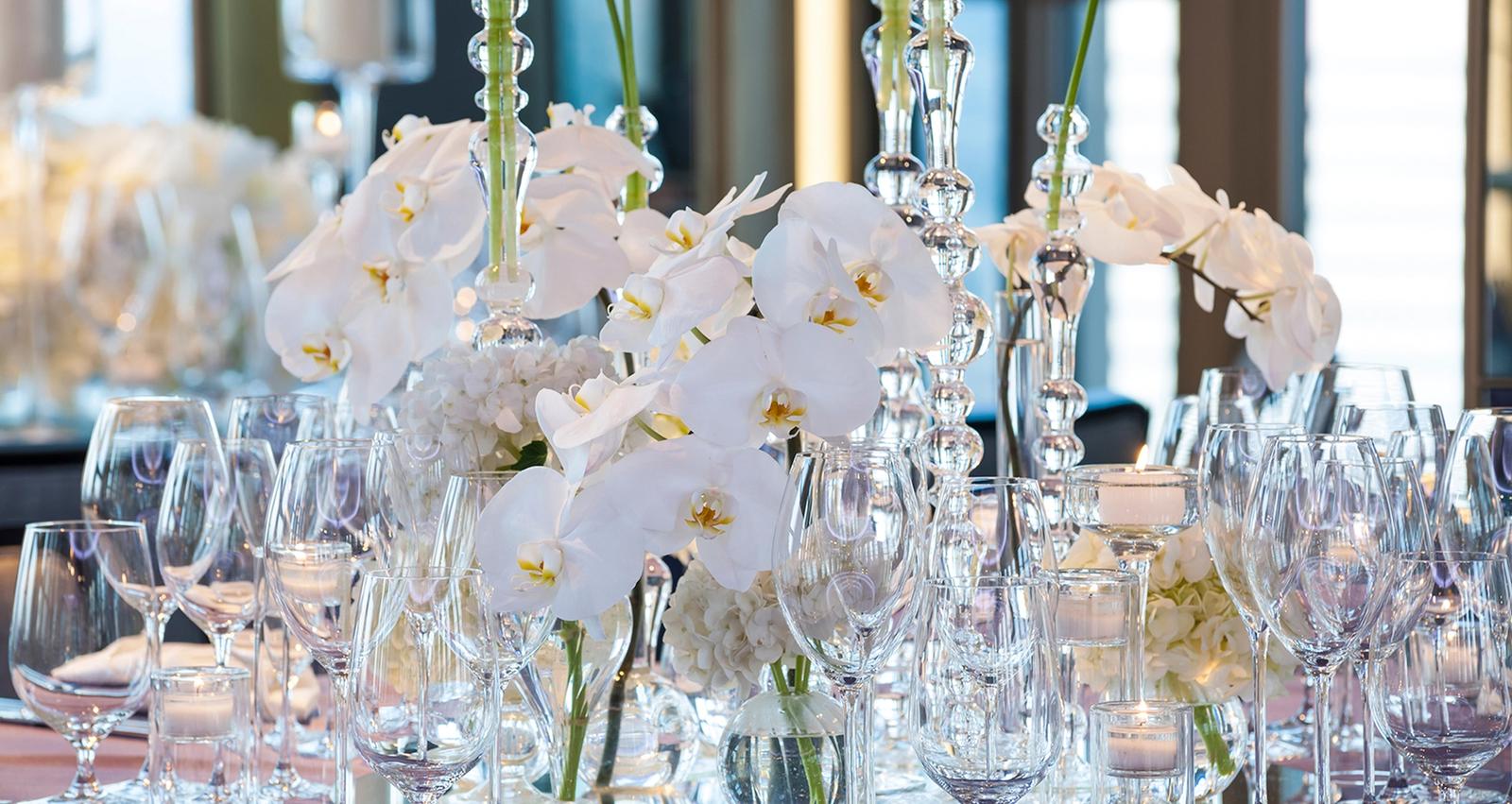 Beautiful Rainbow Room table setting with white flowers and crystal glassware 