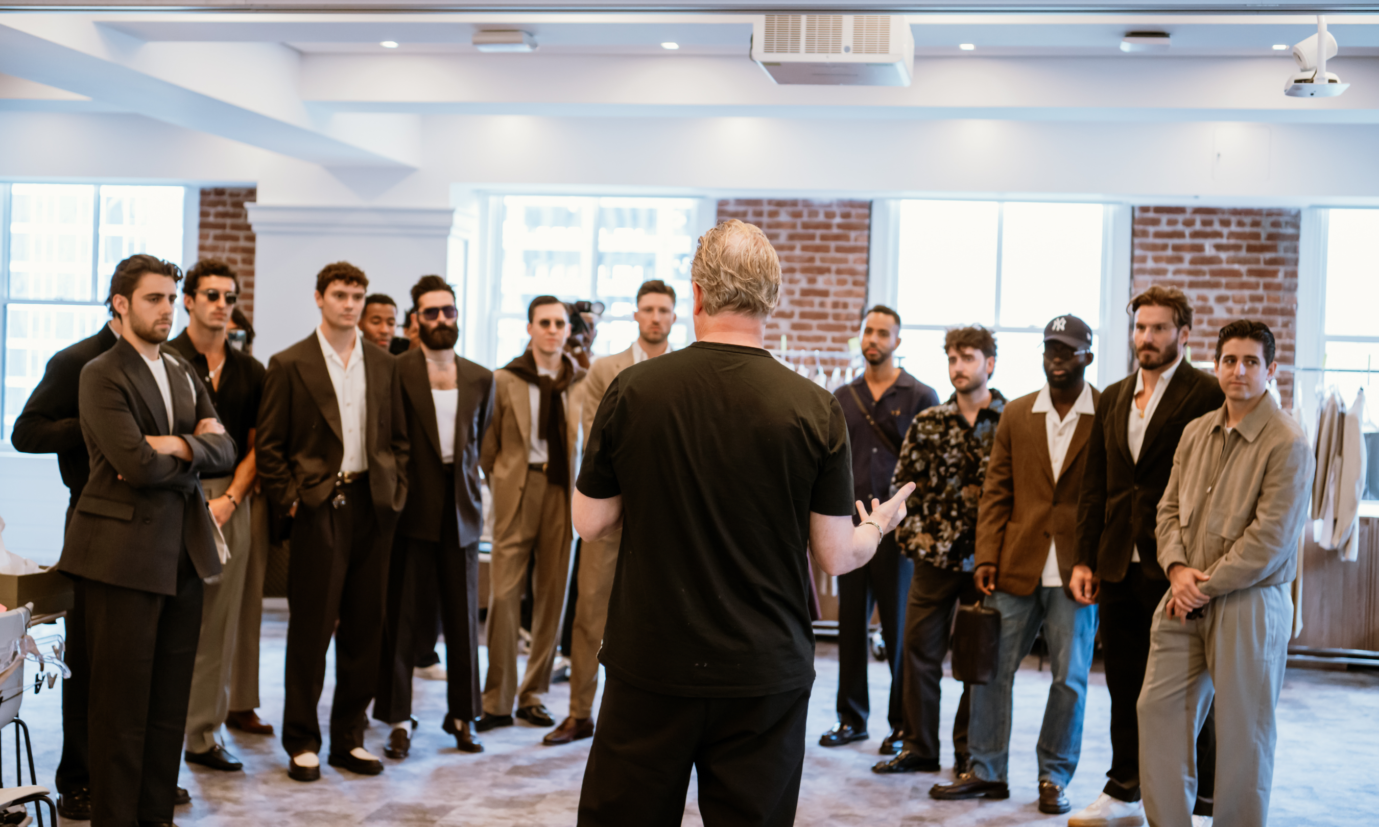 Clothing designer Todd Snyder speaking to a group of models before his 2024 NYFW show at Le Rock