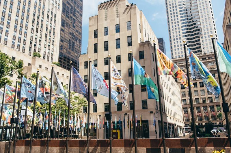 Raised flags around The Rink at Rockefeller Center