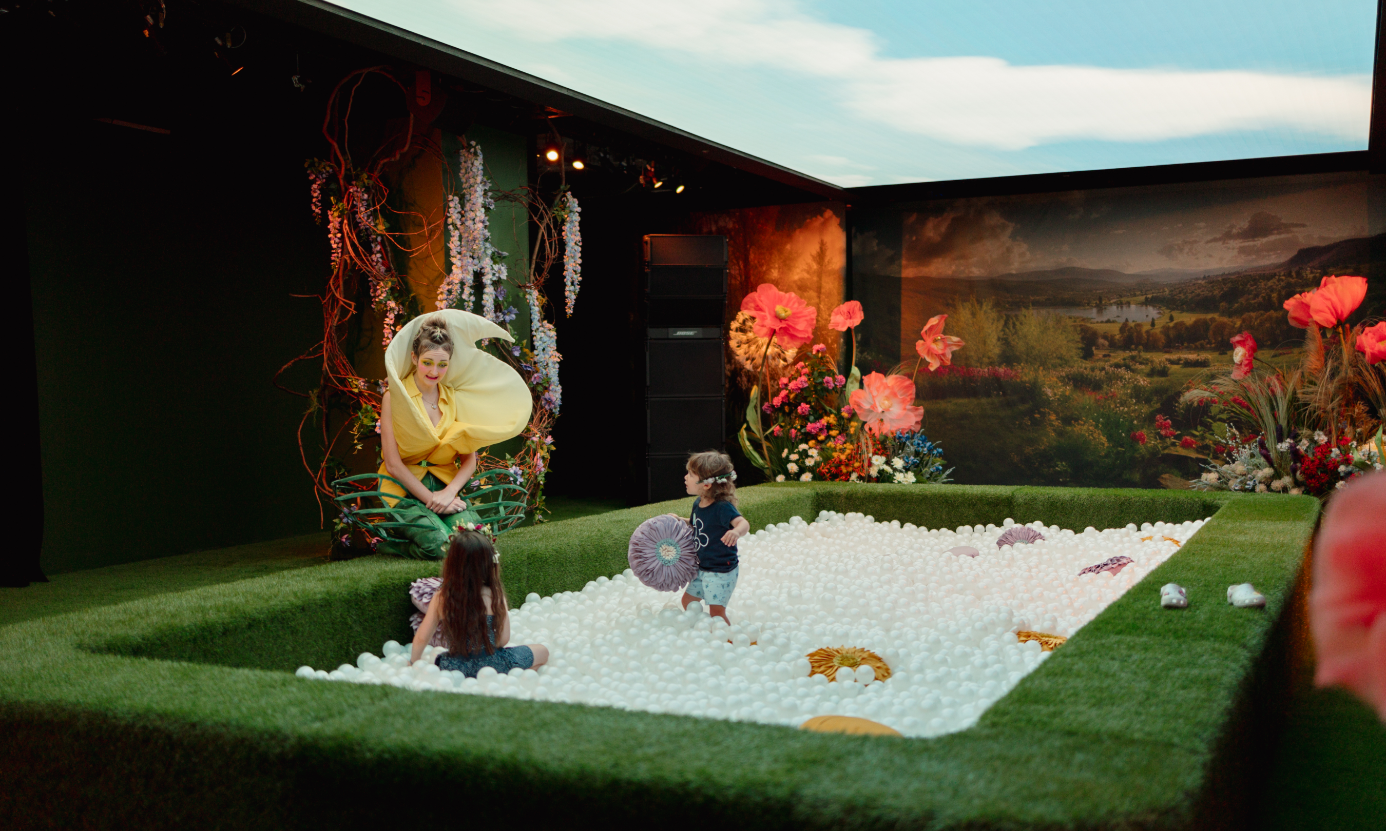 Two children playing in the ball pit inside BLOOM at Rockefeller Center