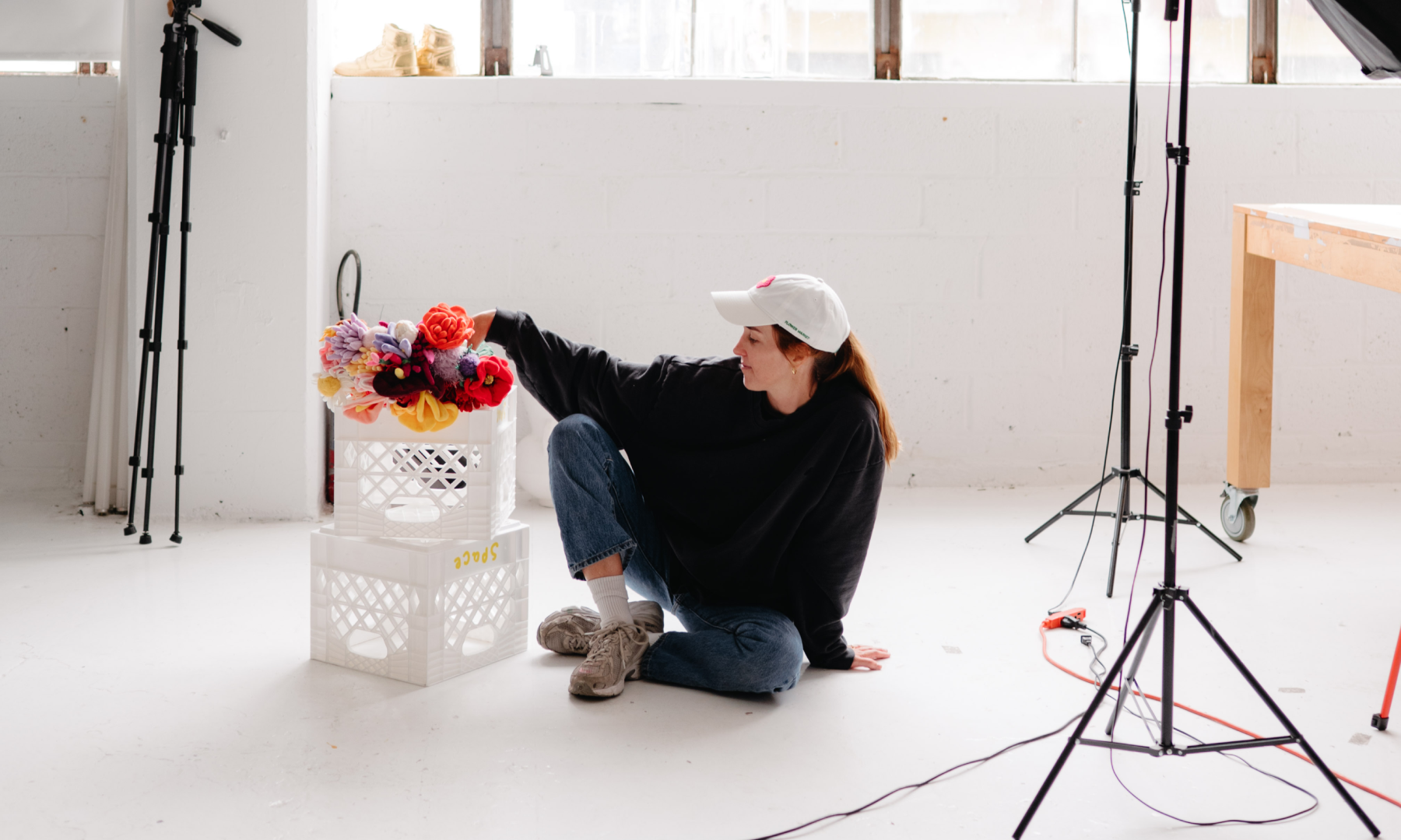 Artist Cj Hendry poses for a photoshoot with her plush flower designs