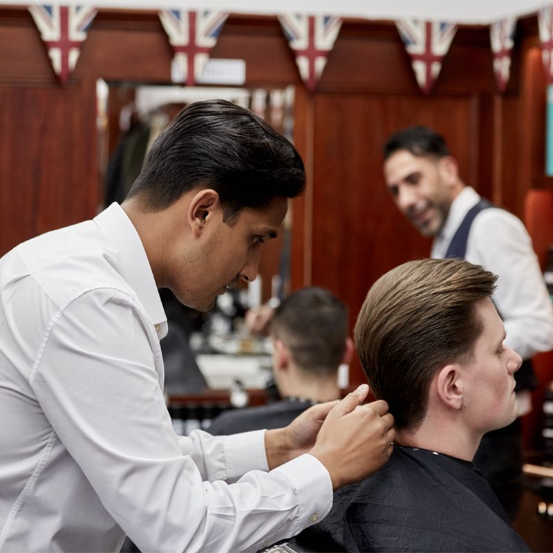 Pall Mall Barber working on a client's hair 