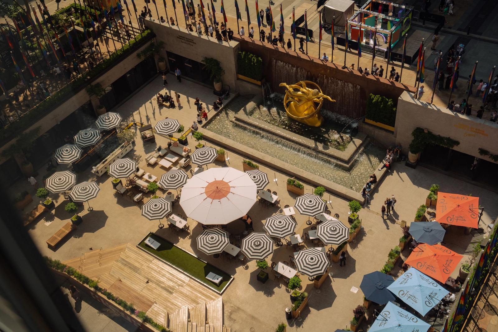 aerial view of the summer rink at rockefeller center with umbrellas and tables