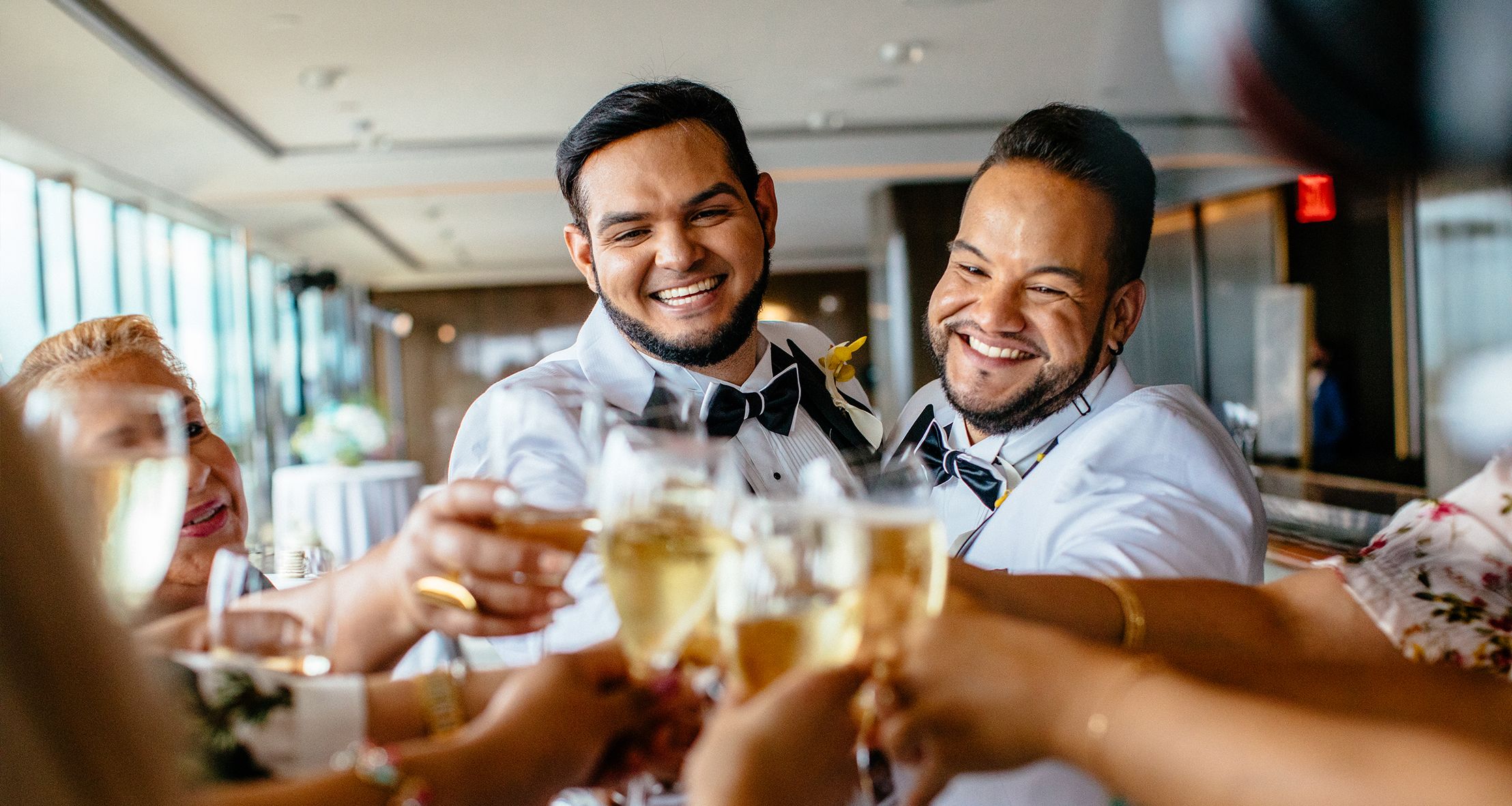 Julio and Argenis doing a toast with family and friends