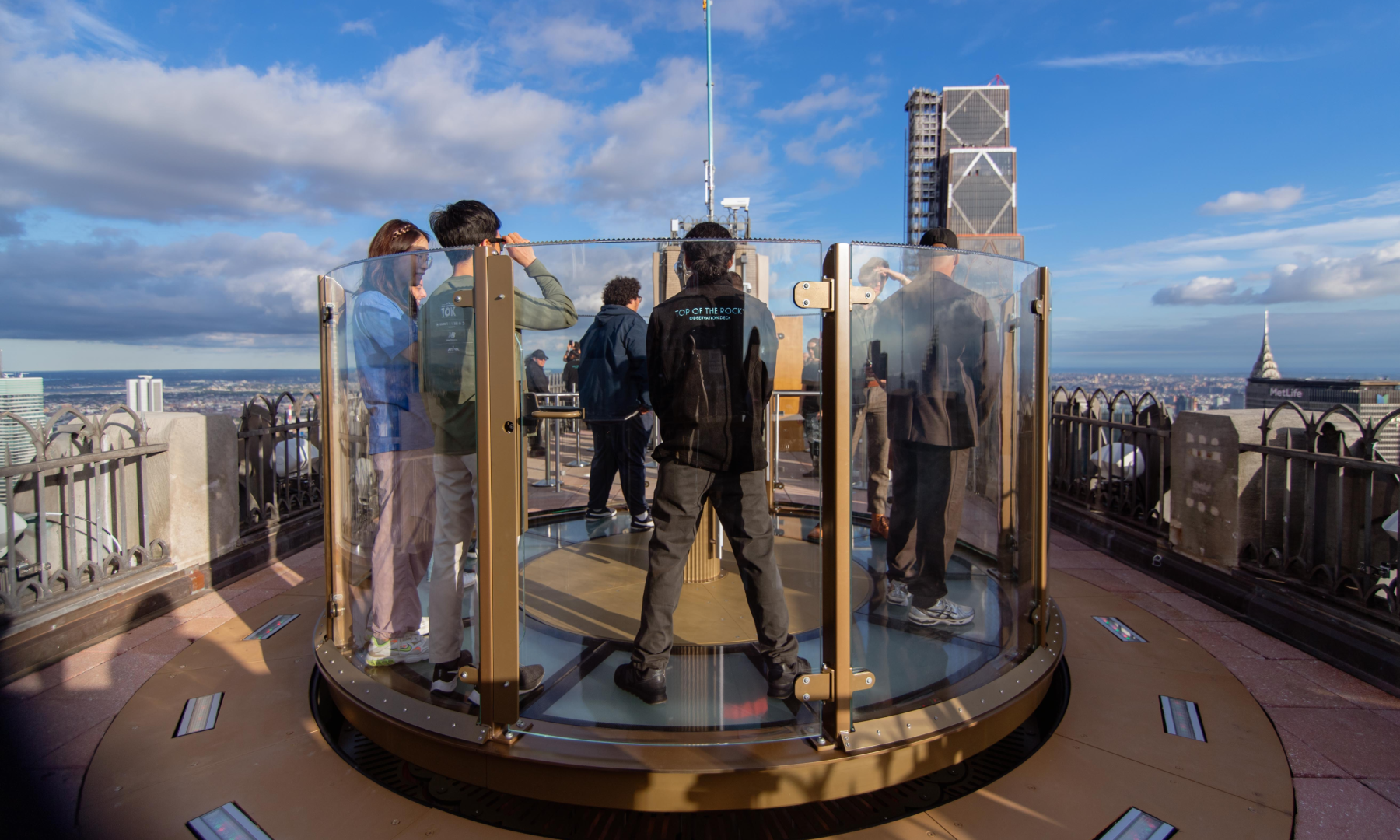 Group of people standing on Skylift's glass platform