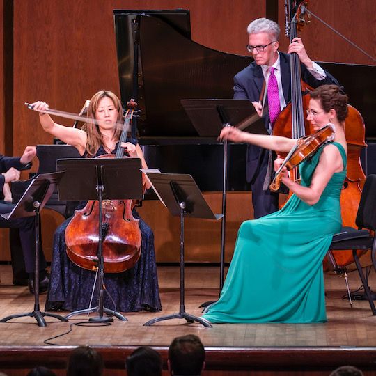 Musicians from the New York Philharmonic performing on stage