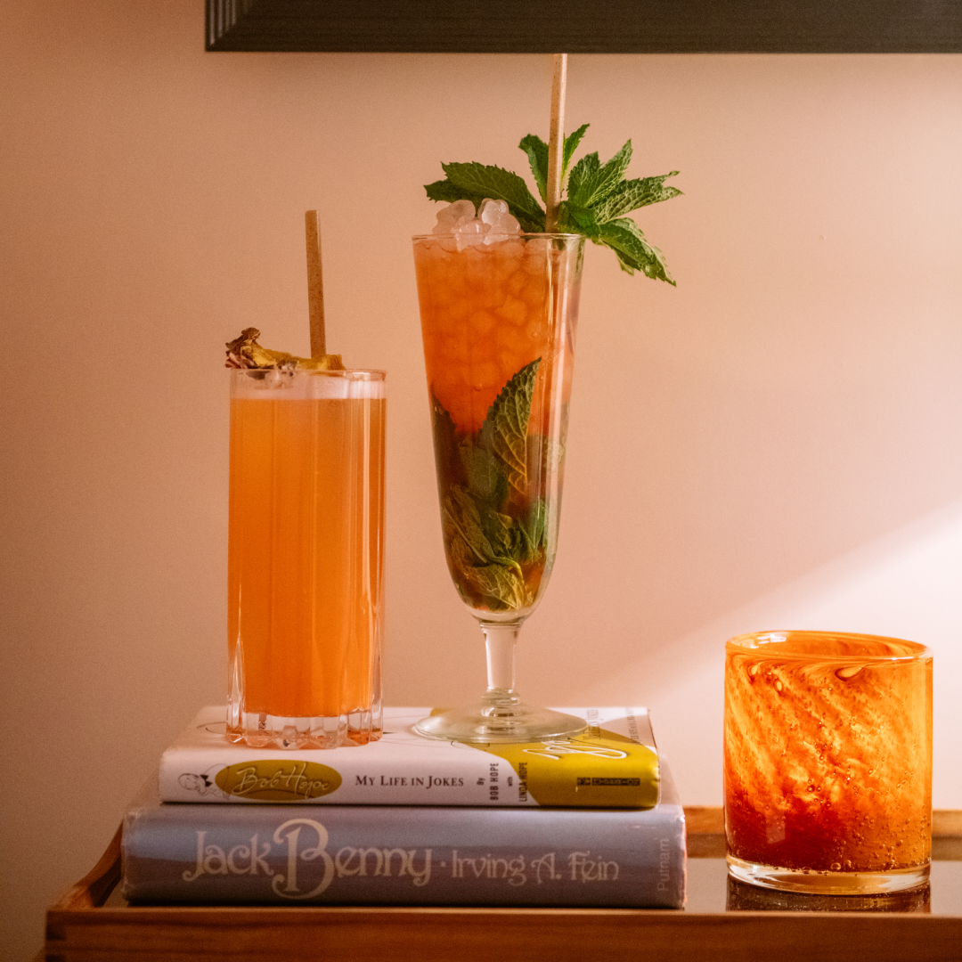 Two cocktails resting on books at Pebble Bar at Rockefeller Center