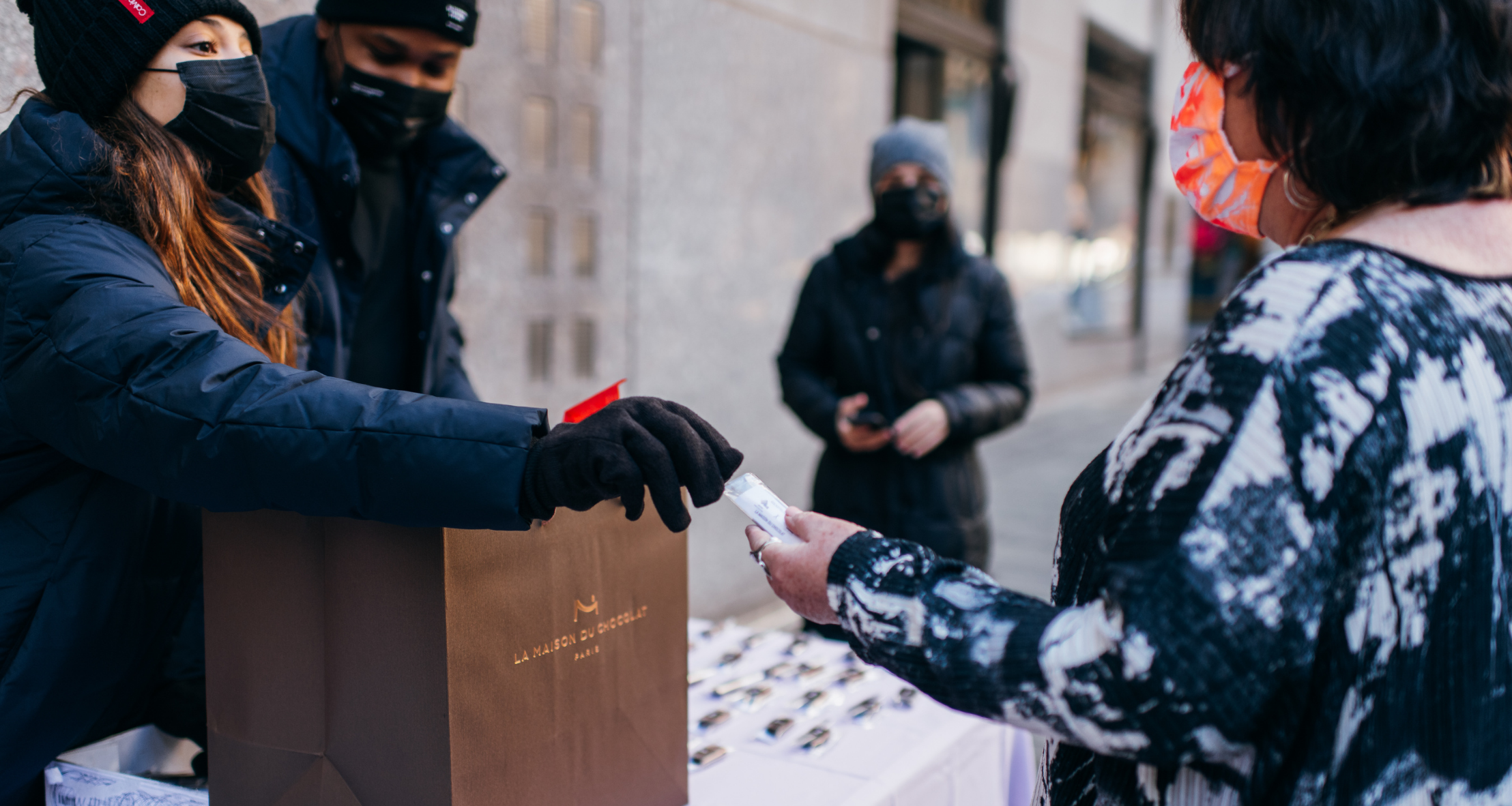 Tishman employees handing out chocolates from La Maison du Chocolat