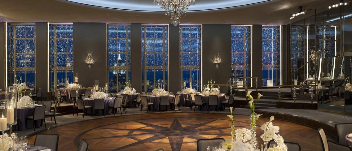 A ballroom with tables and a dance floor