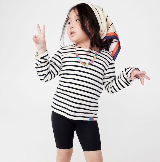 Child wearing a black-and-white striped t-shirt from Kule