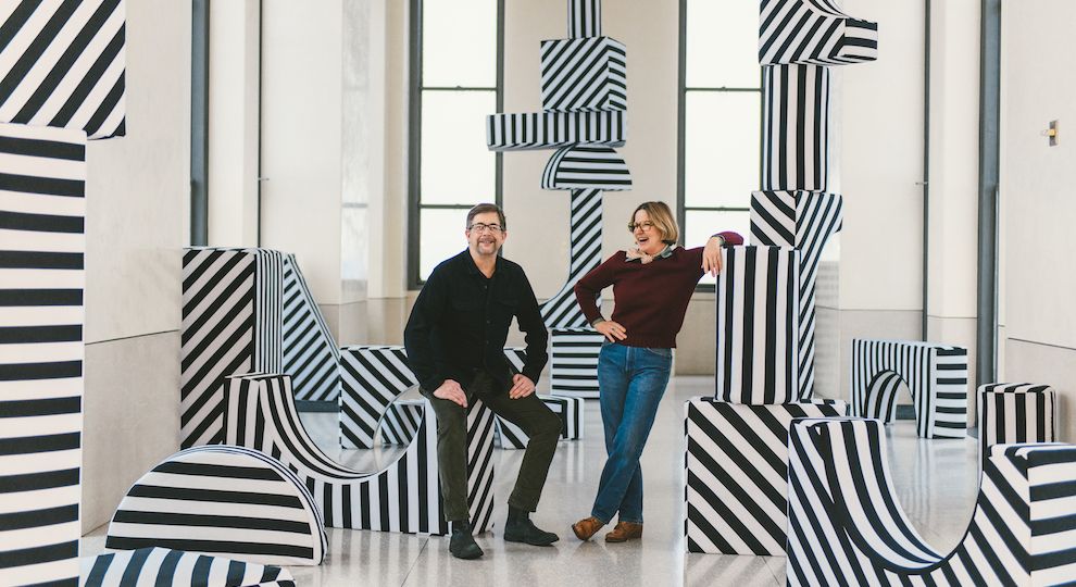 Martin Duffy and Kris Moran pose in front of their interactive art installation BUILDINGS AND BLOCKS at Top of the Rock