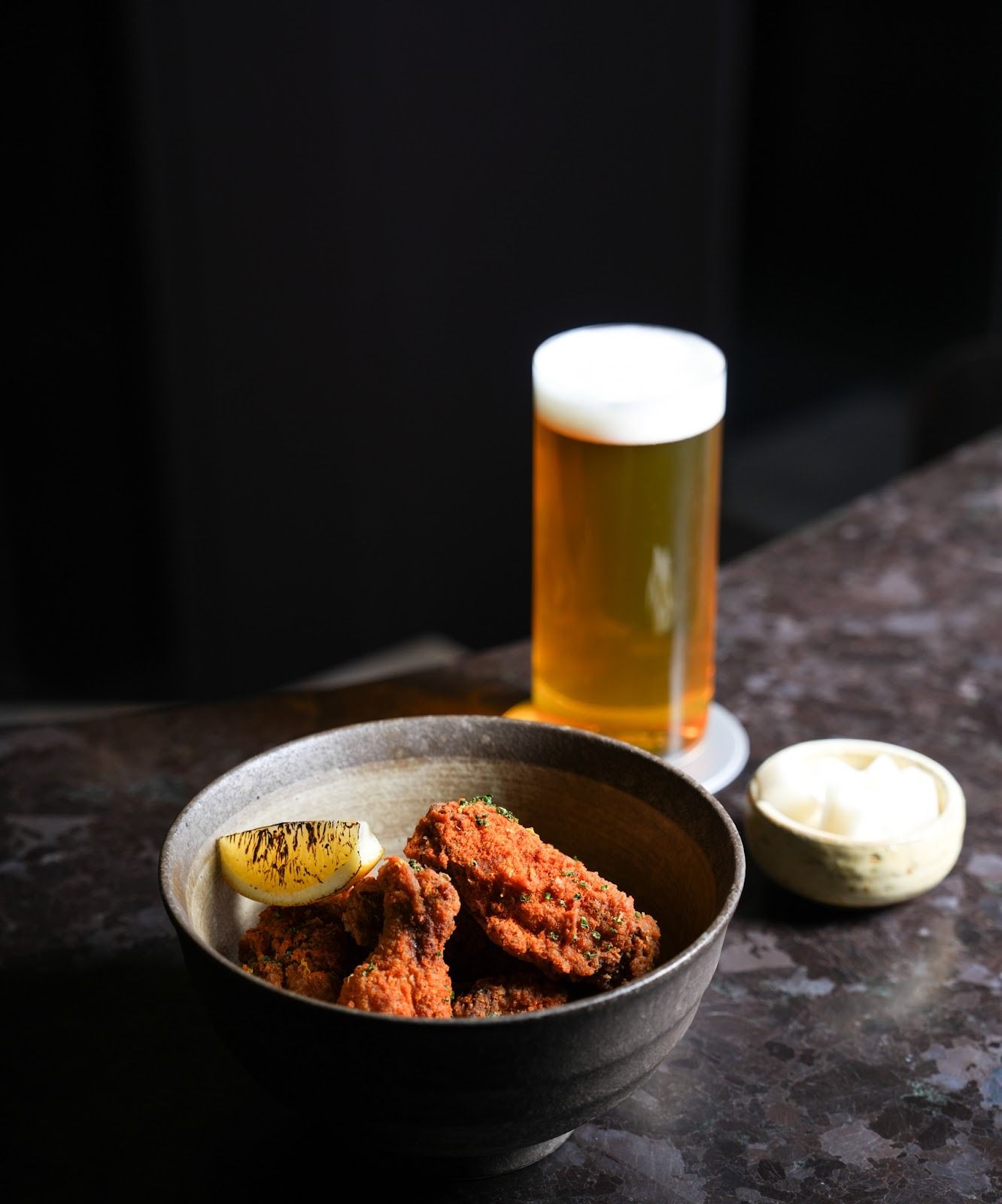 bowl of chicken wings and a glass of beer
