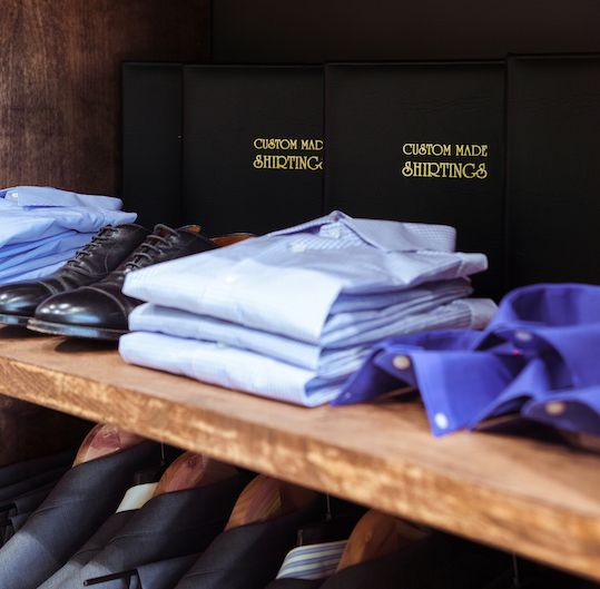 Shoes and stack of dress shirts from Freemans Sporting Slub