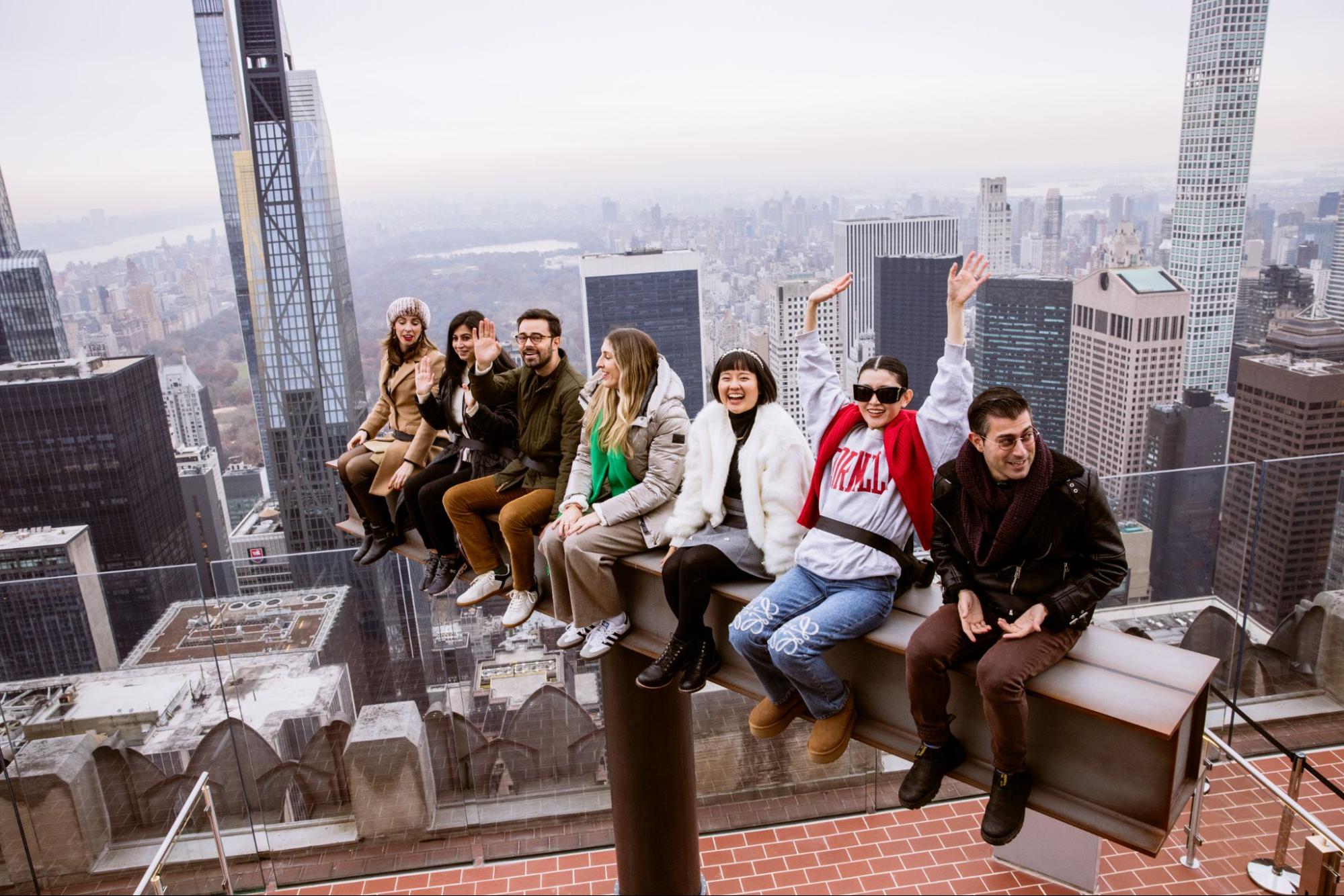Group sitting on The Beam at Rockefeller Center