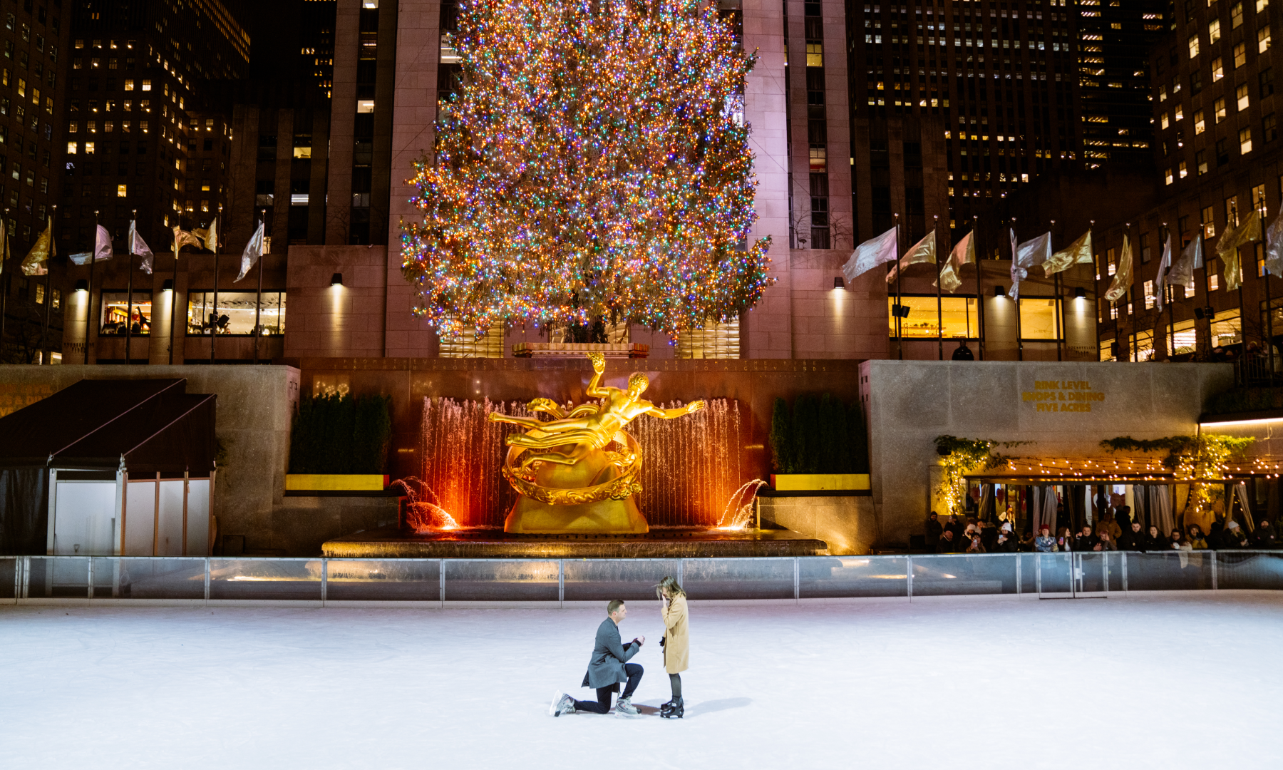 A man proposing to a woman on The Rink at Rockefeller Center