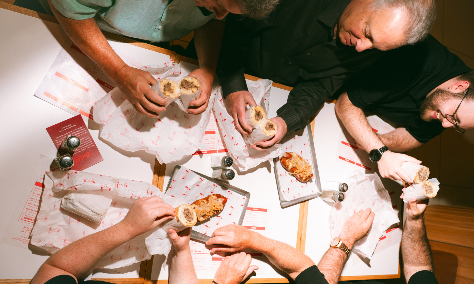 The Lobel family eating sandwiches at their new Rockefeller Center location