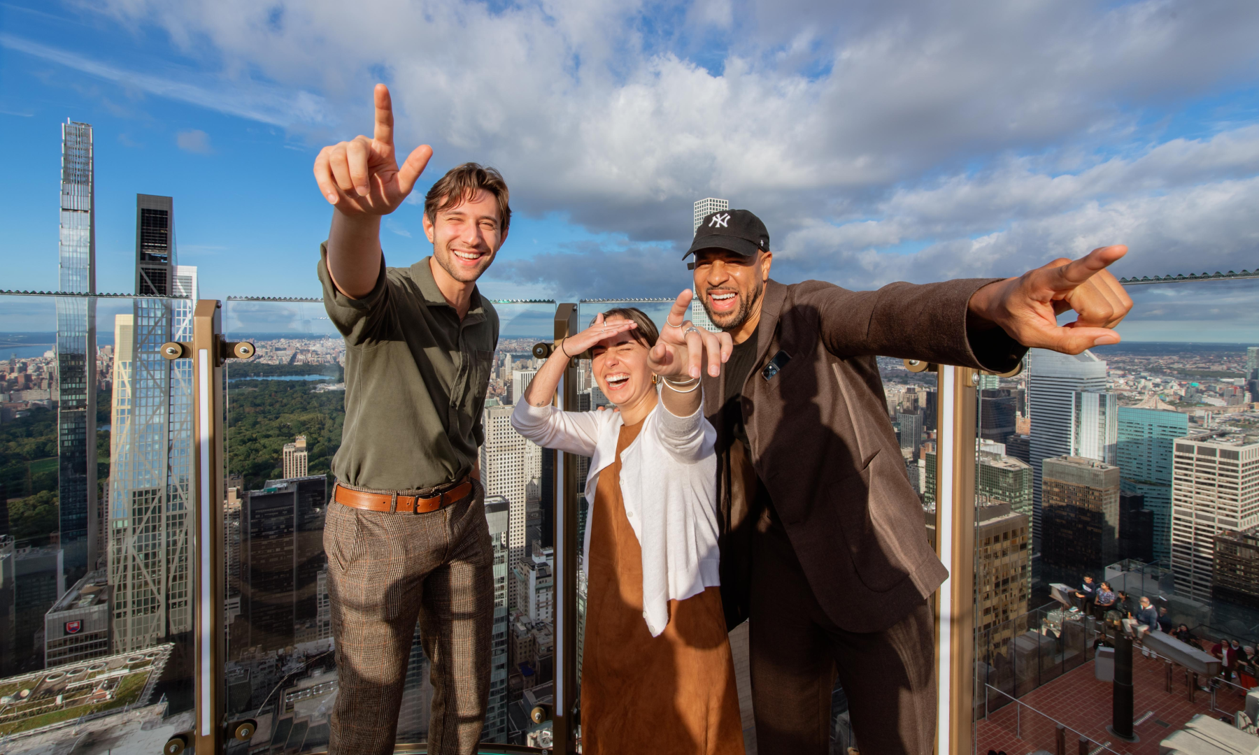 Three people posing for a photo on Skylift at Top of the Rock