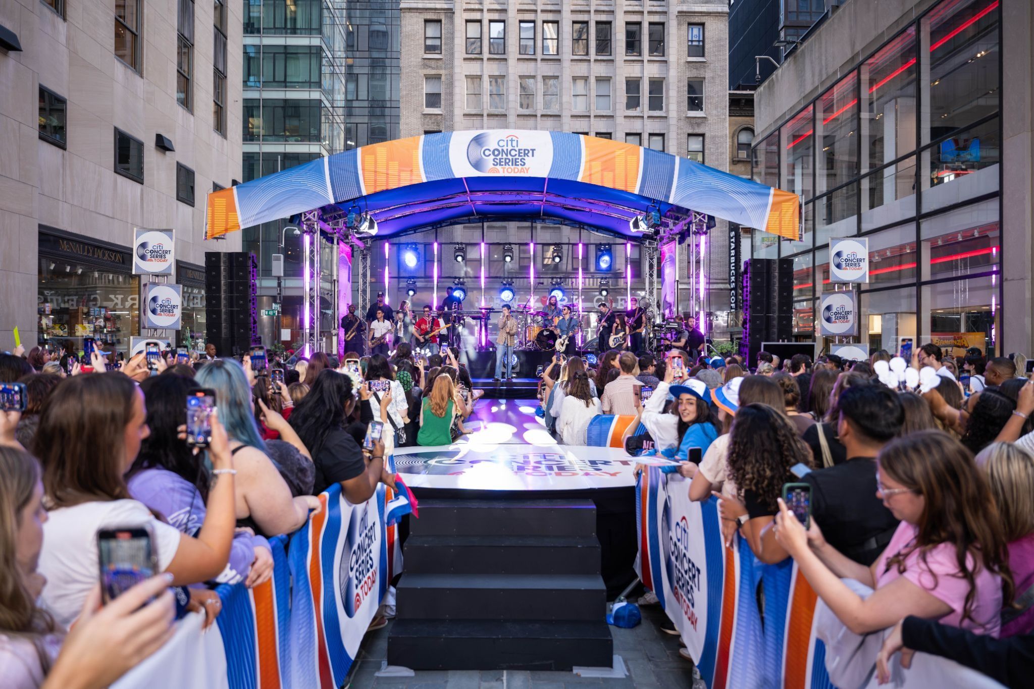 people watching a show on the rockefeller center stage