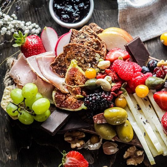 Charcuterie board with assorted meats, cheeses, and fruits