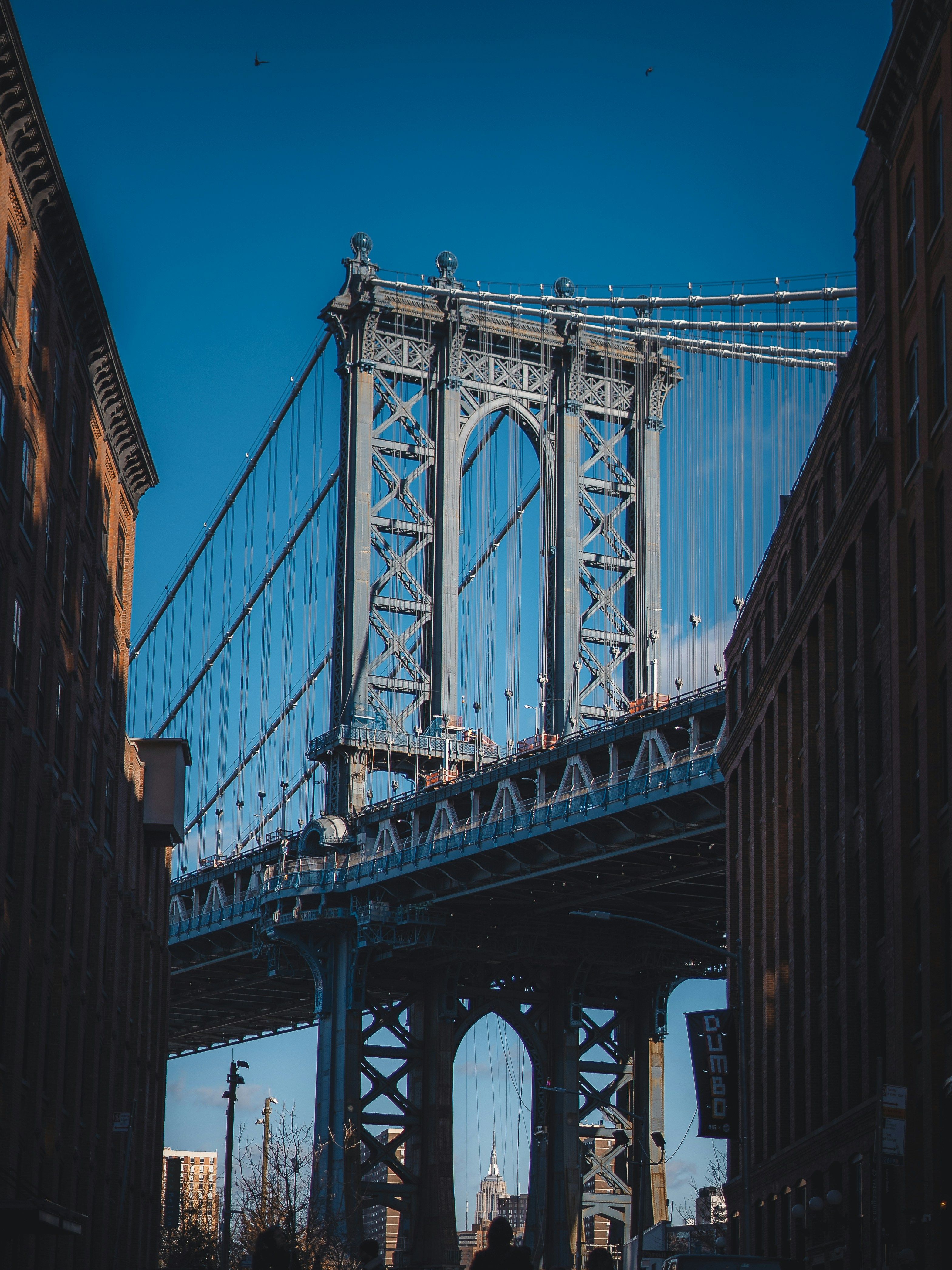 The Manhattan Bridge framed by brick buildings on Washington Street in DUMBO.
