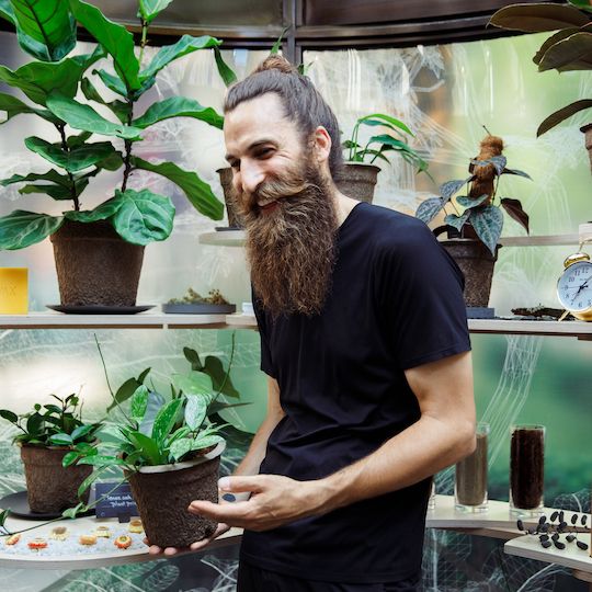 OBSERVED founder Philip Kayden holding a plant