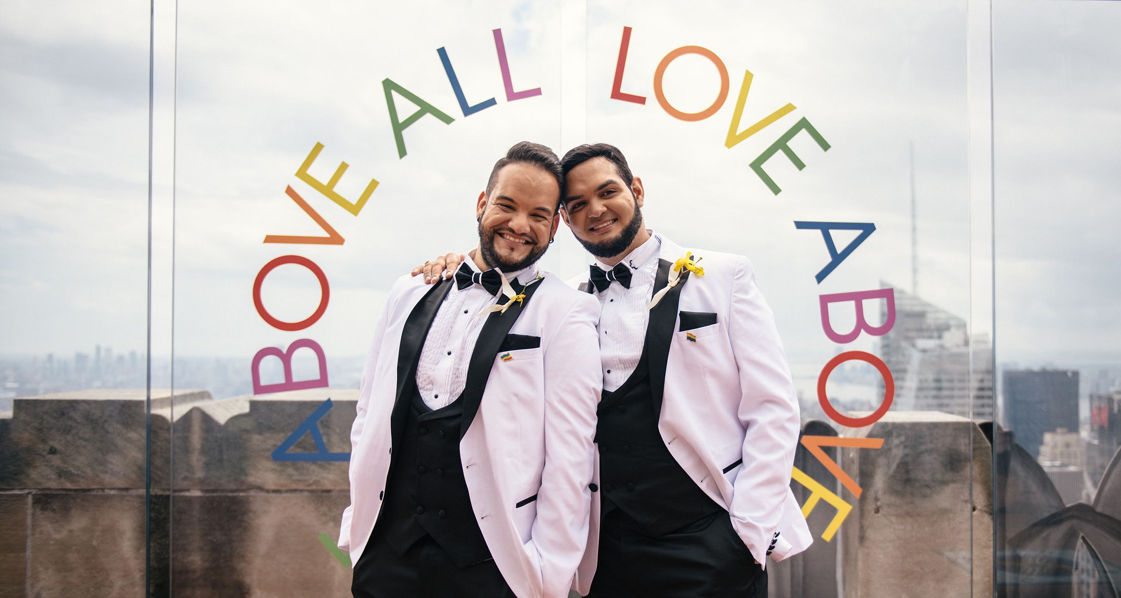 Julio and Argenis posing at Top of the Rock on their wedding day