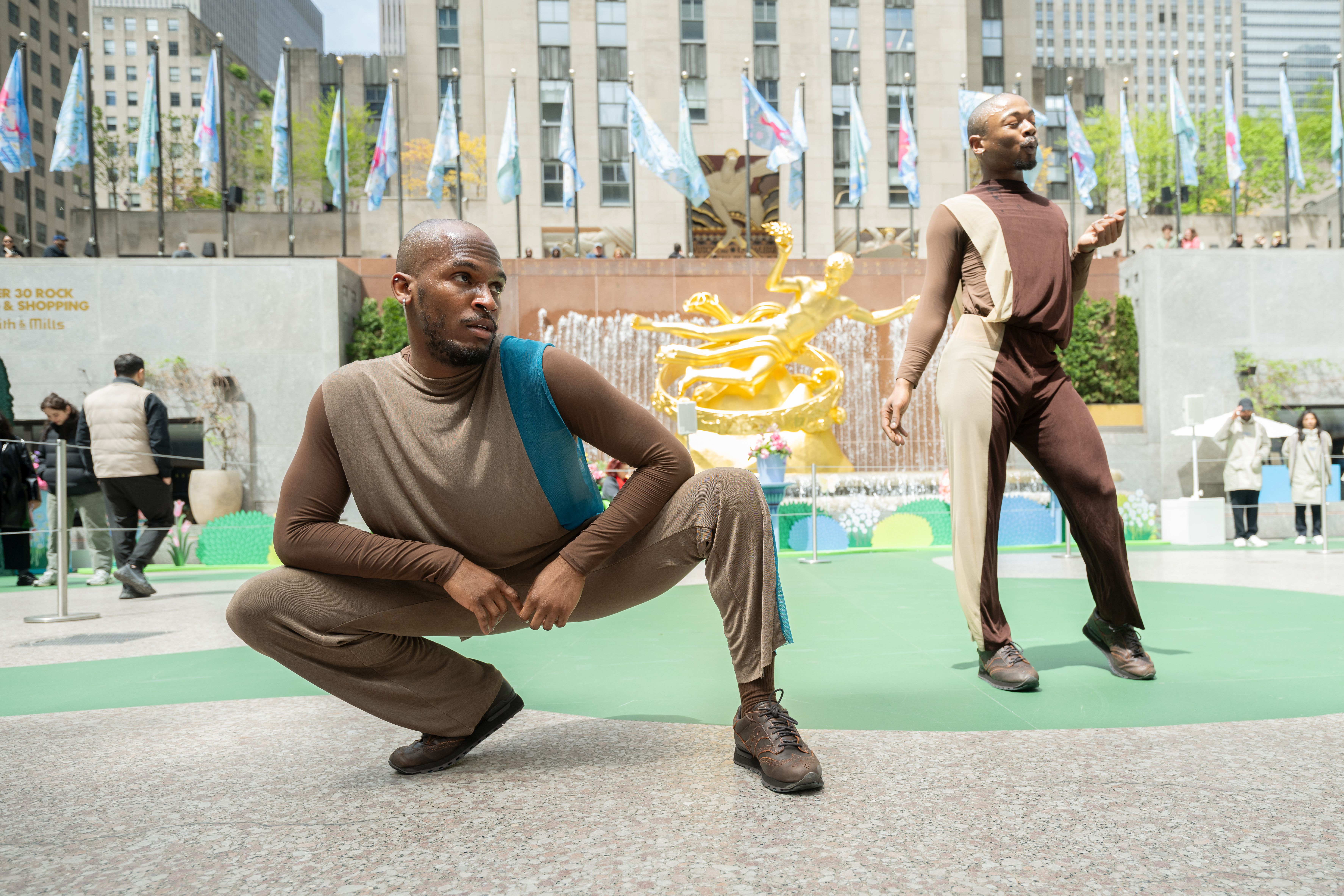 Two dancers performing during the Van Cleef & Arpels Spring is Blooming installation at Rockefeller Center