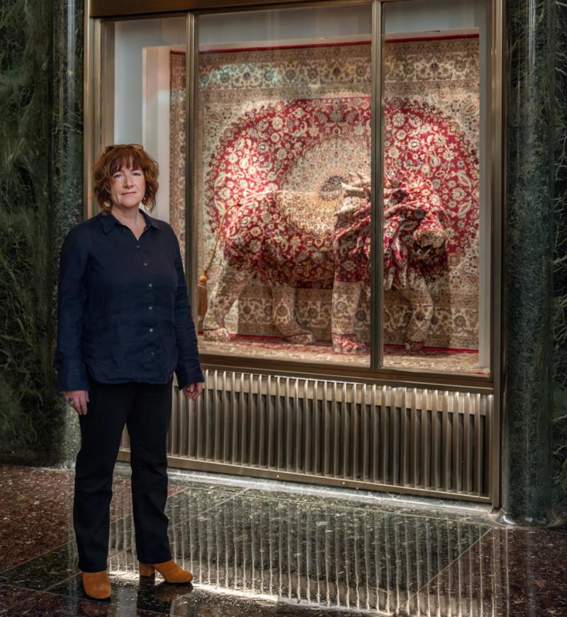 Artist Debbie Lawson standing next to her artwork at Rockefeller Center