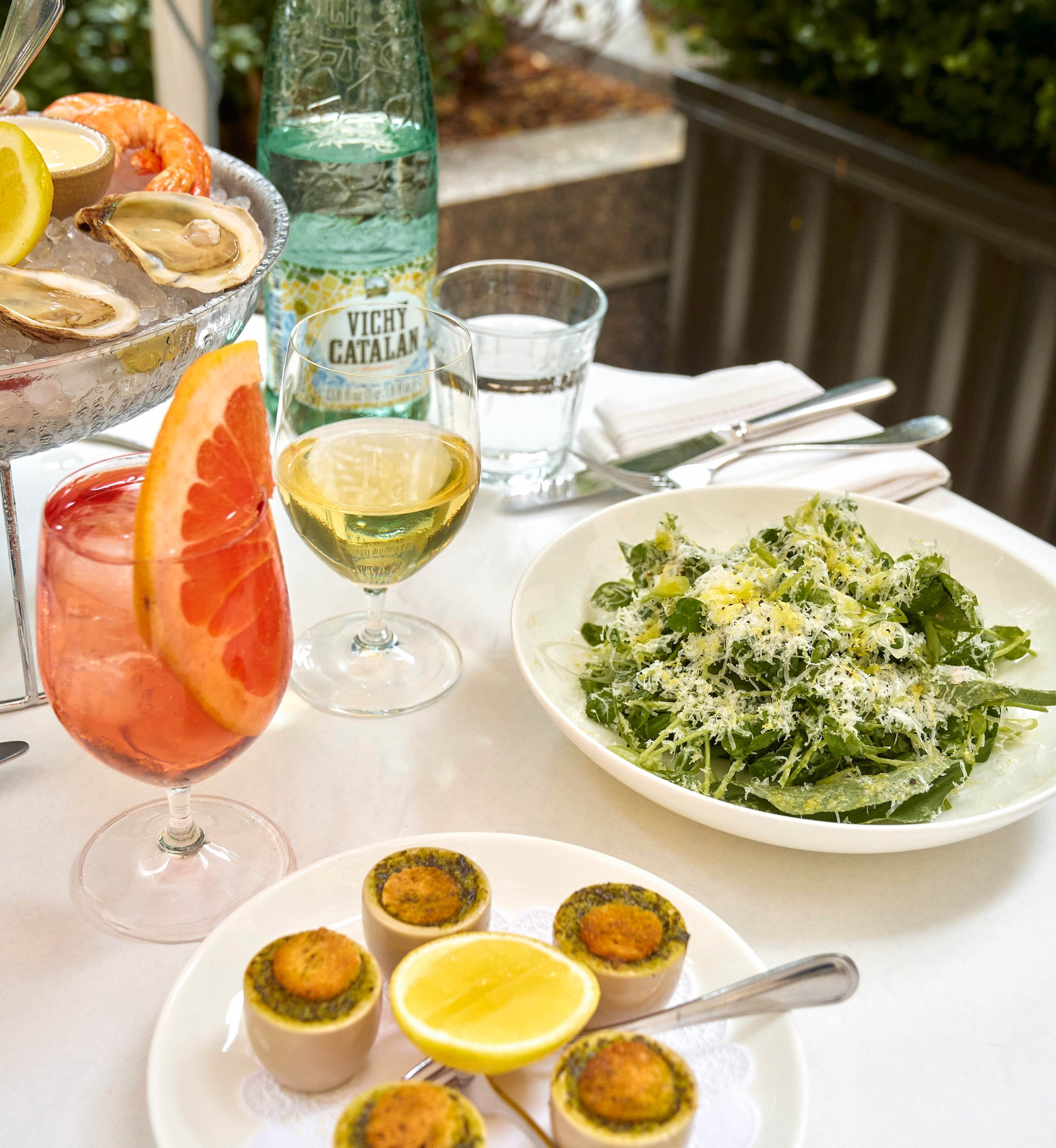 Plates of food and cocktails from Le Rock at Rockefeller Center