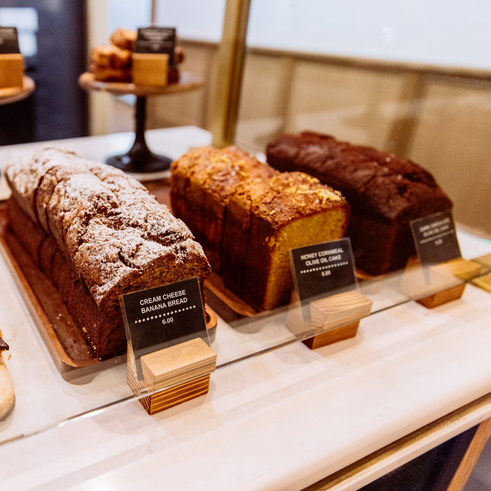 Three cakes on display at The Tipsy Baker at Rockefeller Center