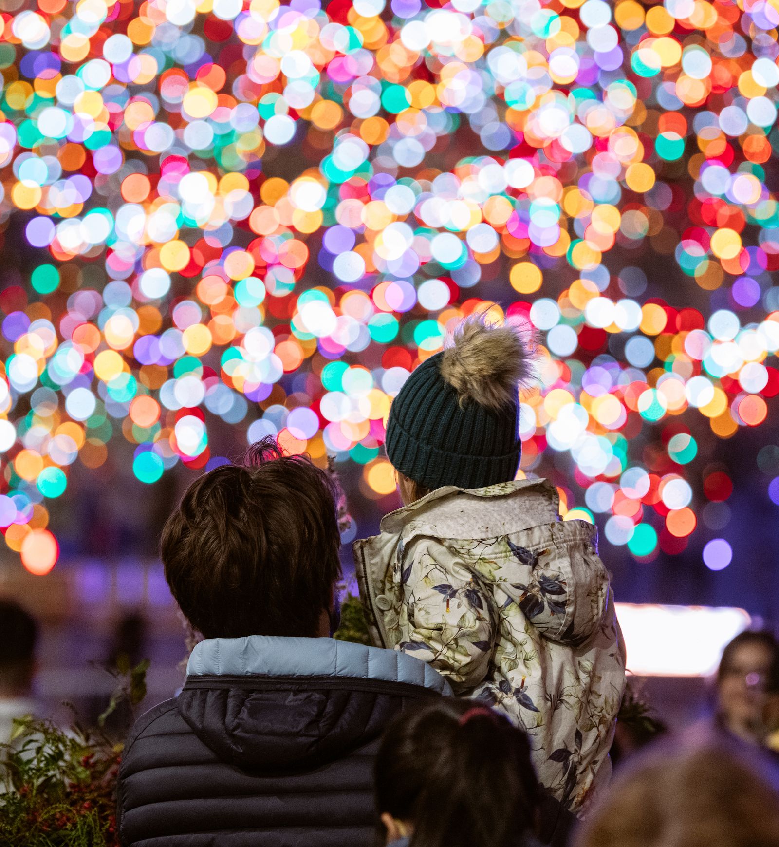 Parent and child looking at the 2021 Rockefeller Center Christmas Tree