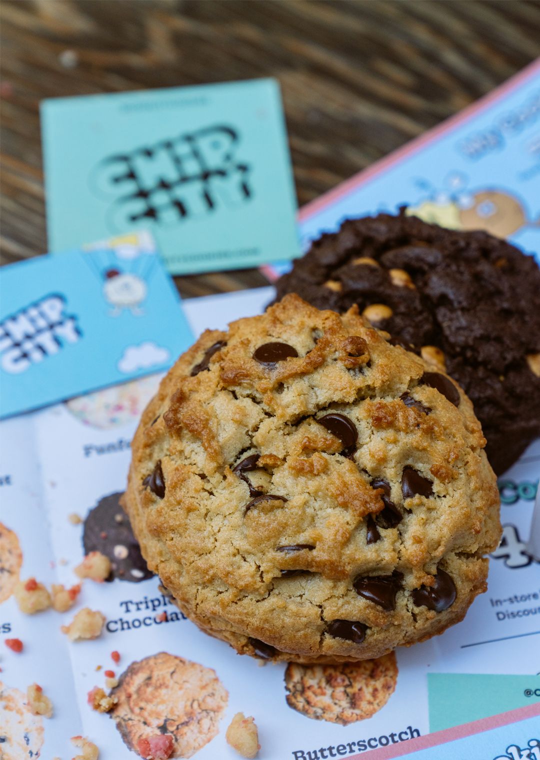 two chocolate chip cookies from Chip City on a table