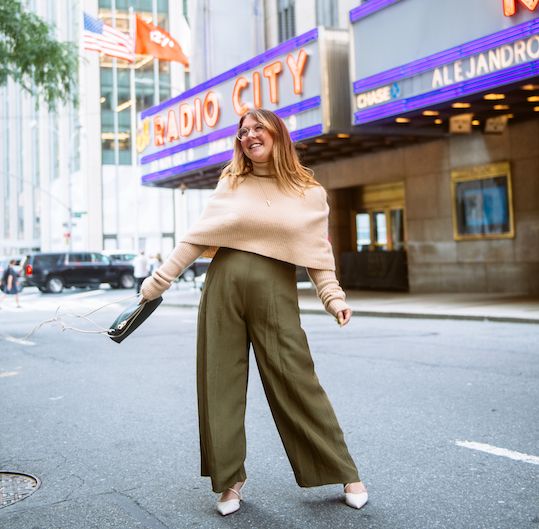 Woman in Jill Lindsey workwear in front of Radio City Music Hall